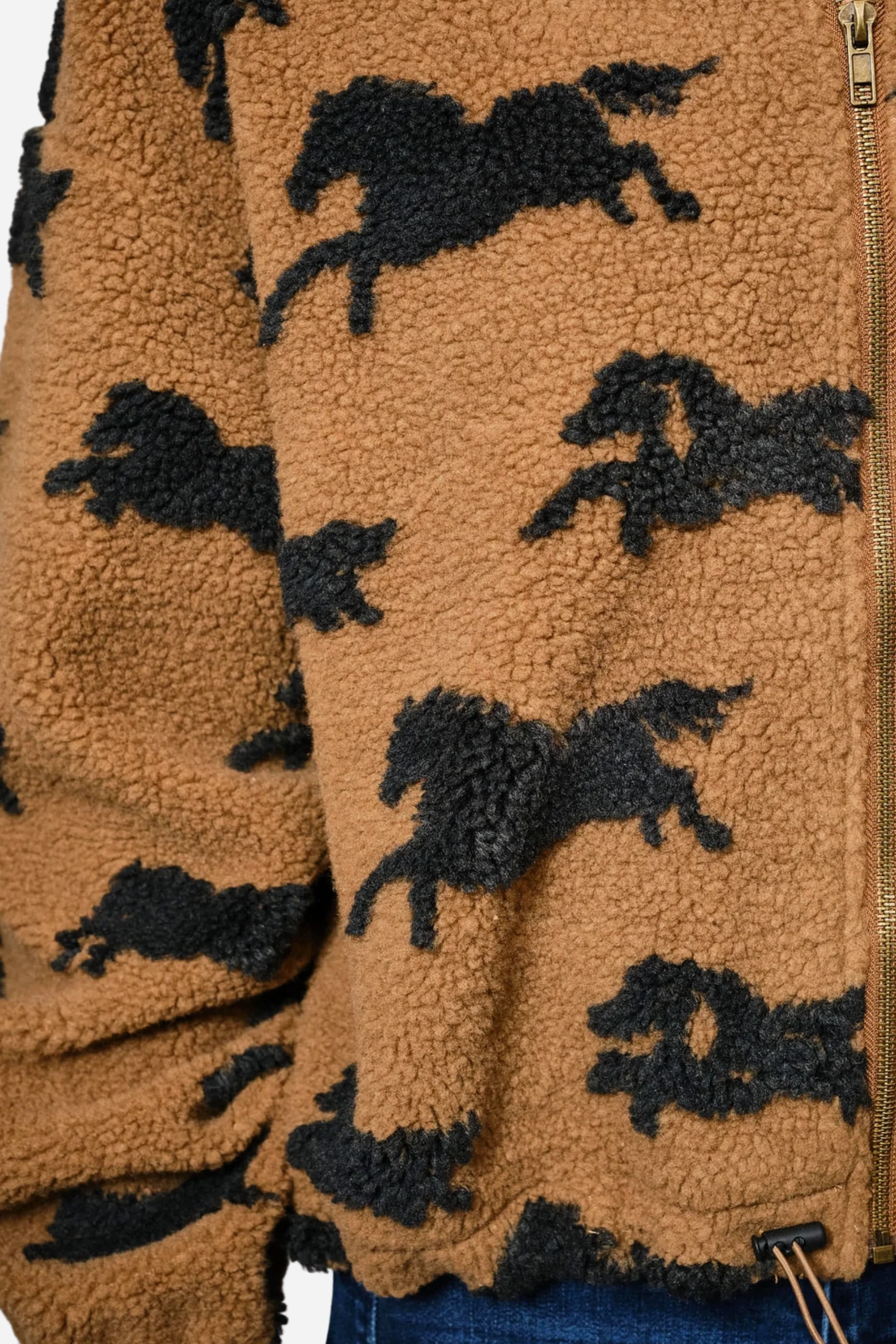 Woman wearing a brown fleece jacket with black horse patterns on a plain background - equestrian sherpa jacket, equestrian jacket, horse print jacket, equestrian outerwear
