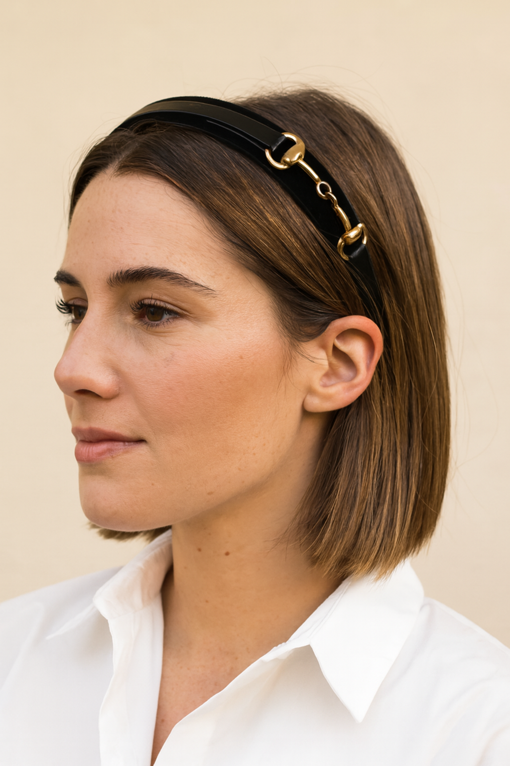 Black headband with gold accents on a white background -Equestrian headband, Snaffle bit headband, Black and gold hair accessory, Women’s equestrian fashion, Horse bit headband, Stylish hair accessories, Classic black headband, Equestrian-inspired style, Everyday chic accessories, Elegant gold detail headband