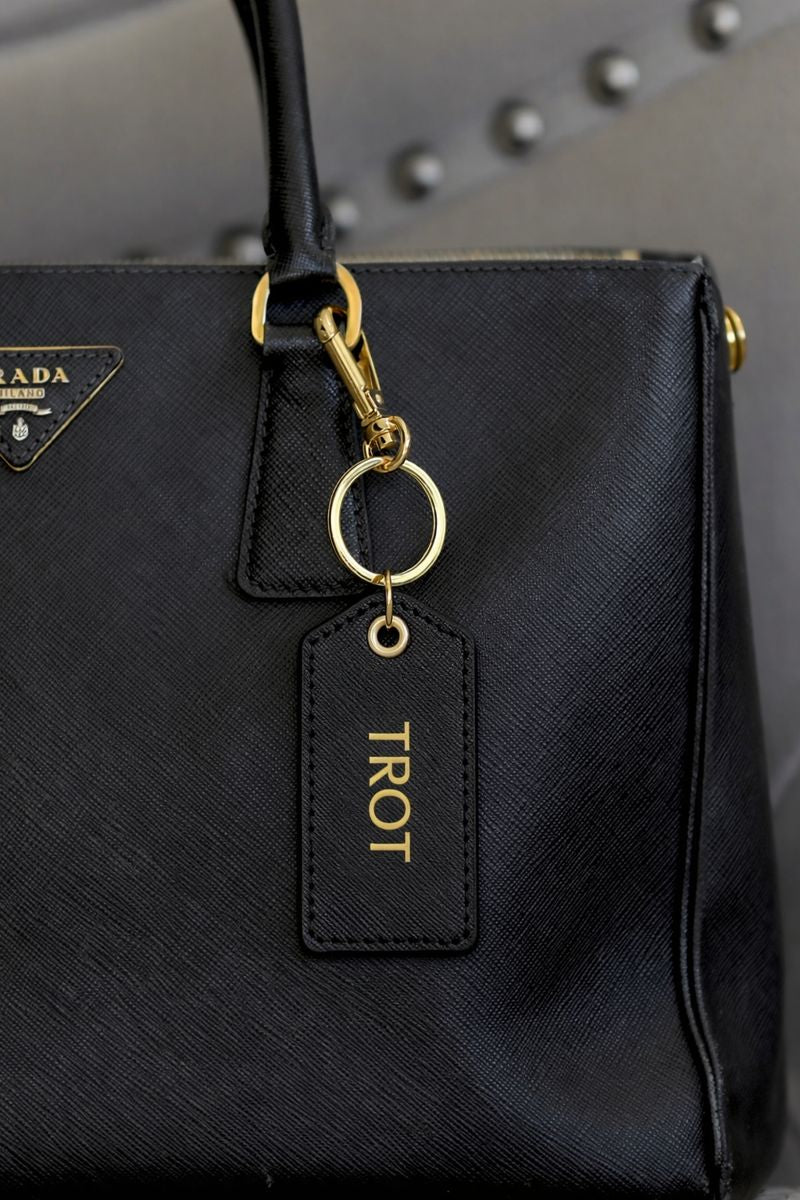 Cleo equestrian key ring in black pebbled leather featuring gold foil equestrian design and gold-tone snap hook