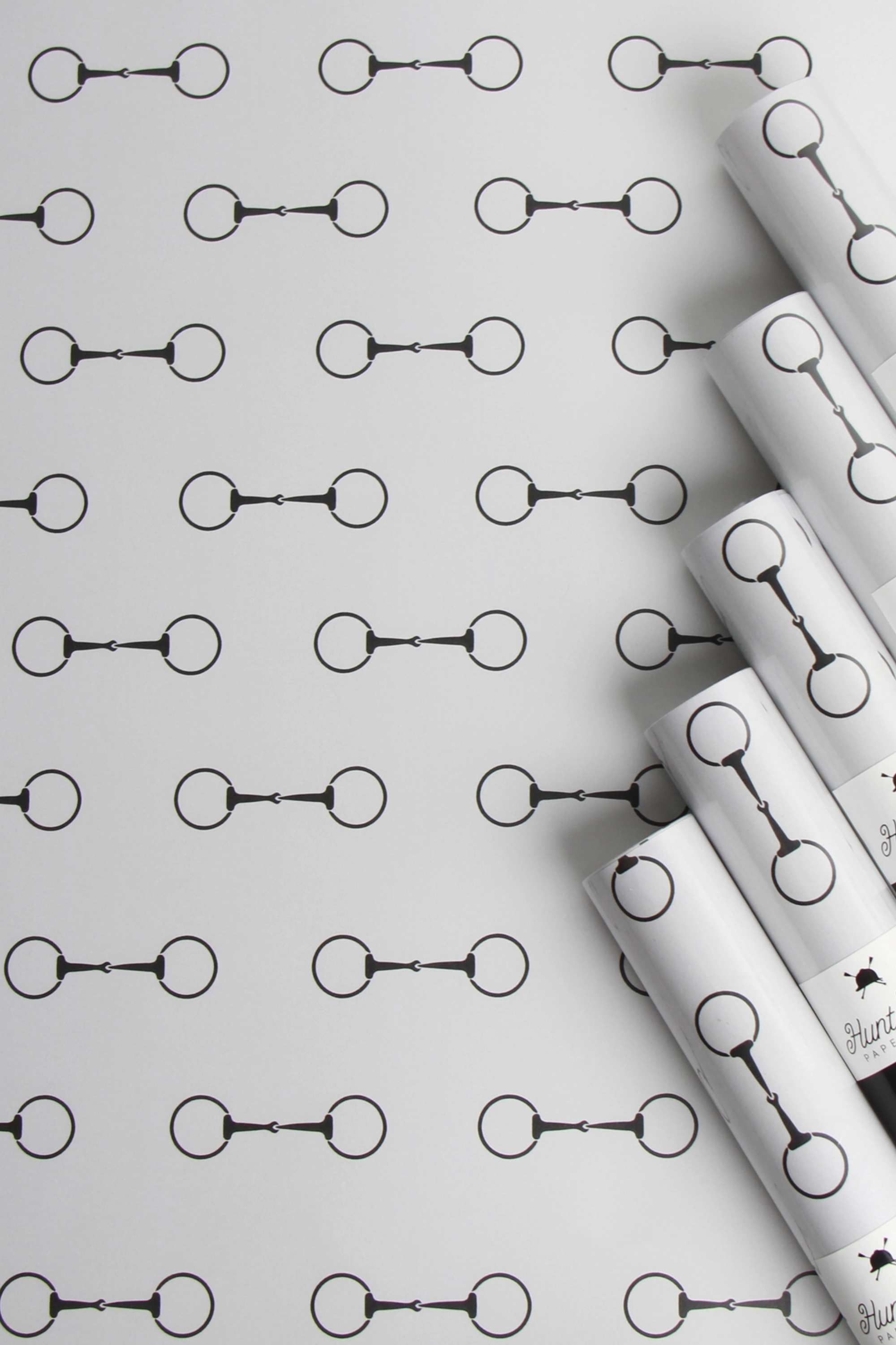 Elegant equestrian gift wrapping paper set featuring a repeating black horse bit pattern on premium textured white paper. Luxury horse-themed gift wrap sheets made in the USA—perfect for horse lovers, equestrian gifts, and stylish holiday packaging.