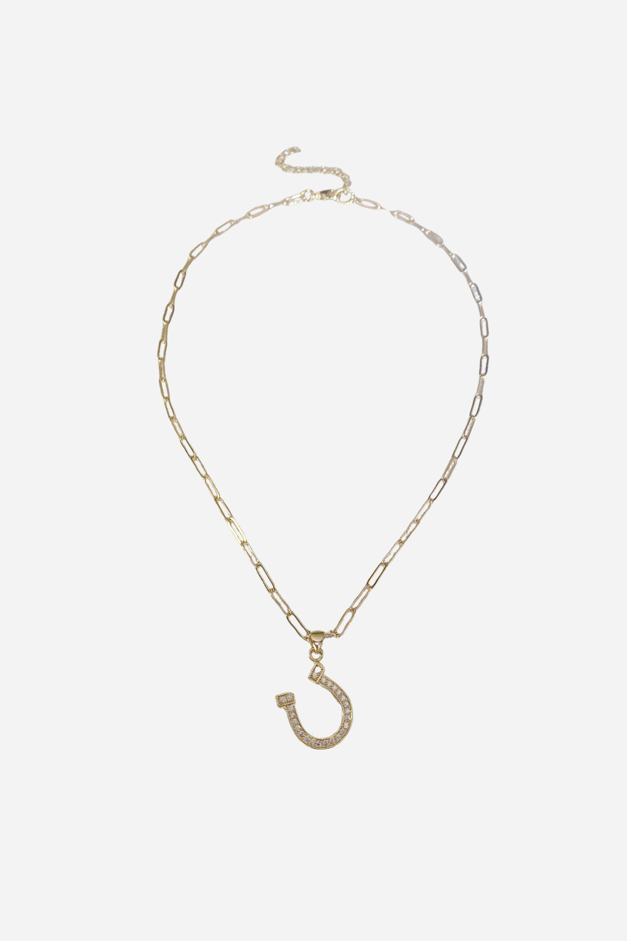 Delicate and dazzling Dion Horseshoe Necklace with a minimalist horseshoe charm suspended from a dainty 16-inch link chain. Perfect for everyday wear.