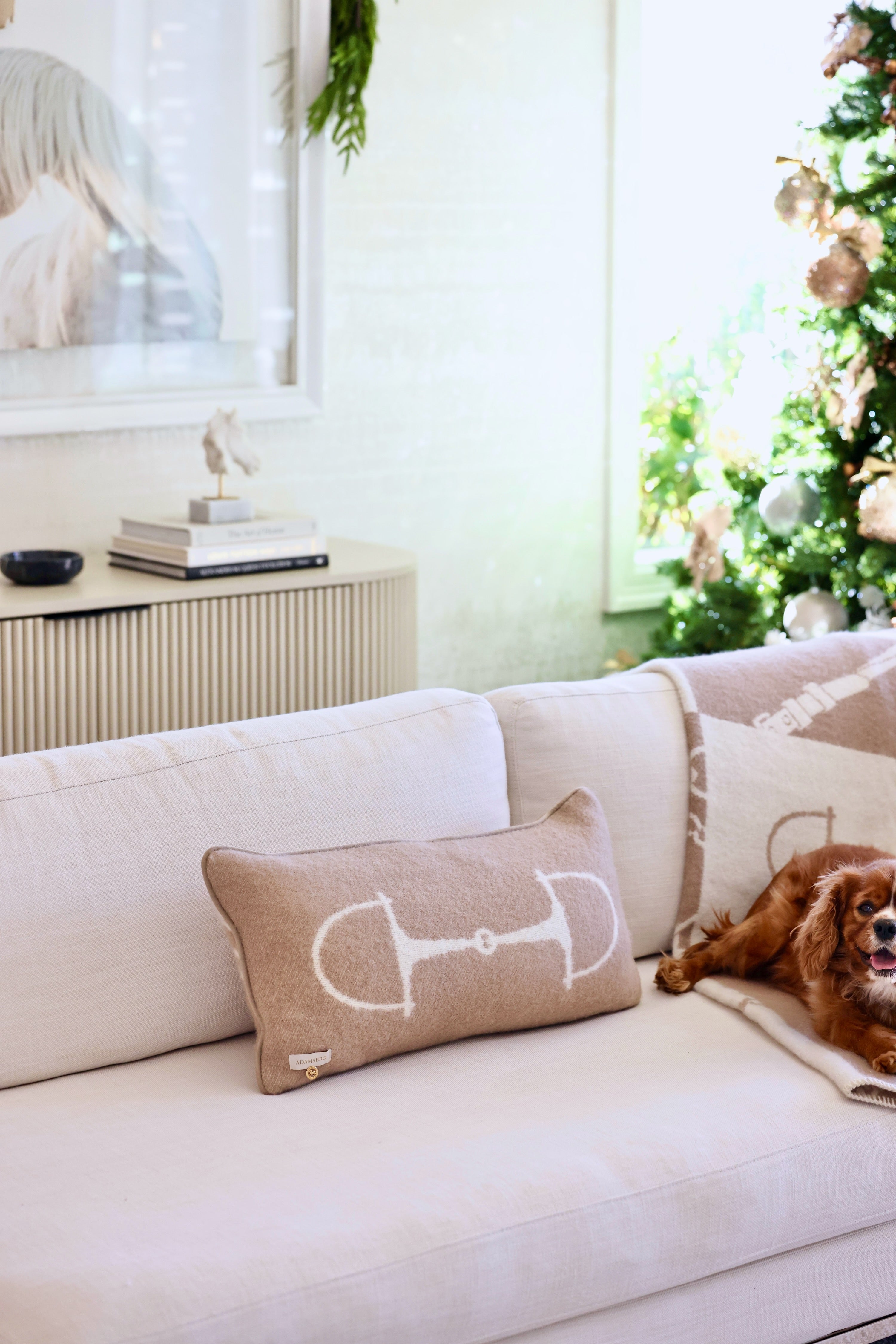 Equine Lumbar Wool Pillow in Spice featuring a rich wool fabric with an elegant horse bit design, faux suede piping, and hidden zipper. A luxurious equestrian-inspired accent pillow perfect for home décor or bedding.