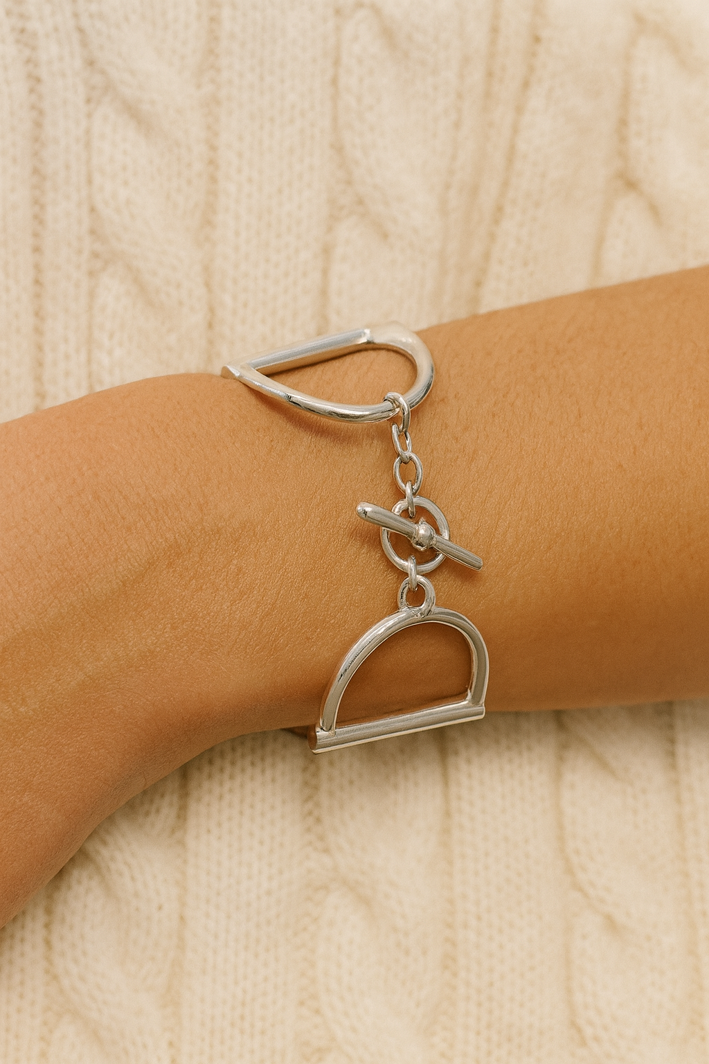 Heritage Bit Bracelet – Silver: a polished, hand-cast 925 sterling silver bracelet featuring geometric shapes and interlocking loops, bold 1½-inch width, and iconic double horse-bit design. Linked by a delicate chain with a signature toggle-and-ring clasp, elegantly curved to fit a 7½-inch wrist, showcasing a modern, minimalist, yet substantial equestrian style.