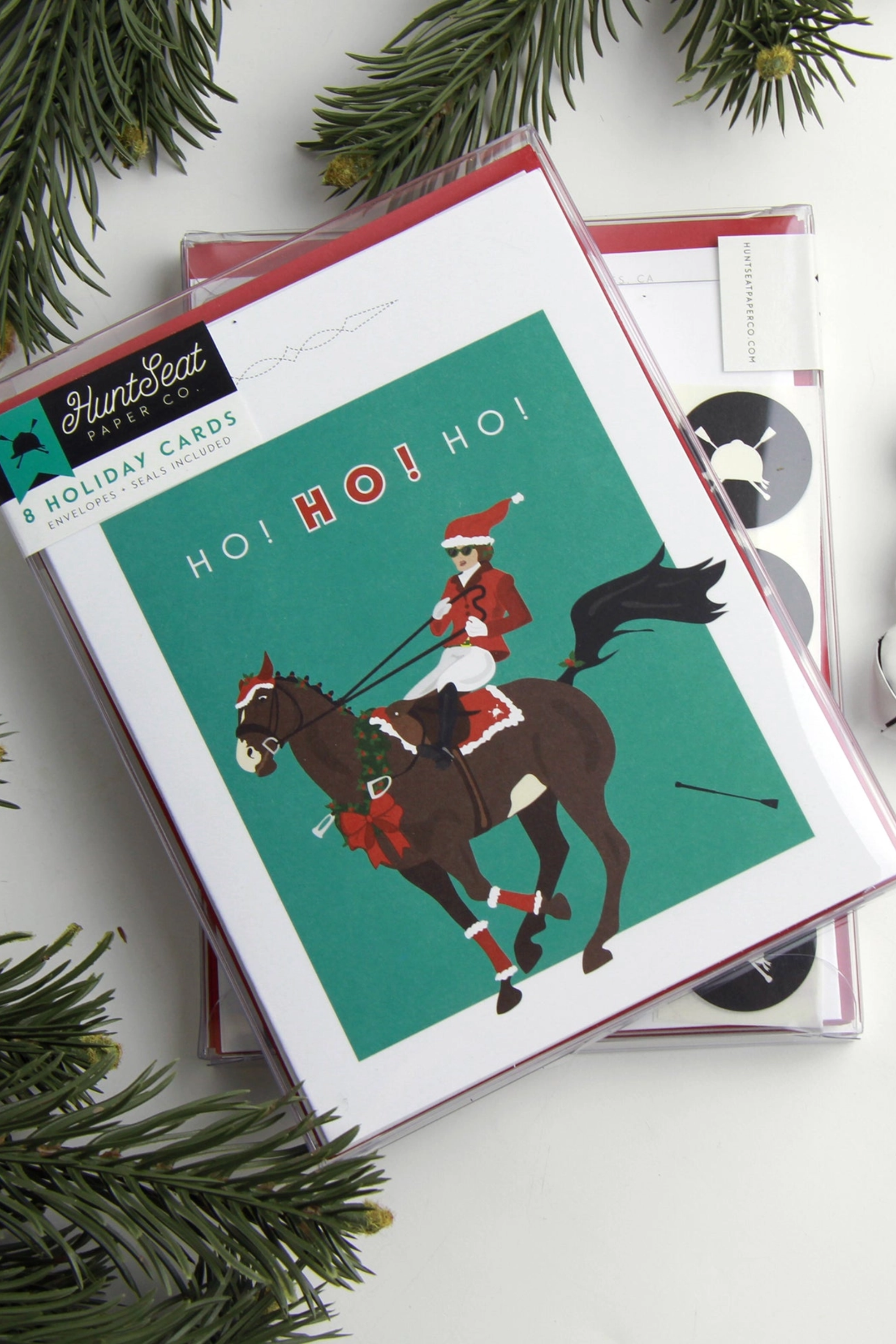 Ho! Ho! Ho! equestrian Christmas card printed on premium A2 14 pt unfinished card stock. Blank inside and packaged in a cellophane sleeve with envelope and seal. Perfect holiday greeting card for horse lovers and equestrian gift giving. Made in the USA. equestrian stationery, horse themed greeting cards, horse Christmas card, holiday horse card, gifts for horse lovers, equestrian holiday card, horse lover stationery, horse themed holiday card, premium equestrian card, made in USA greeting card.