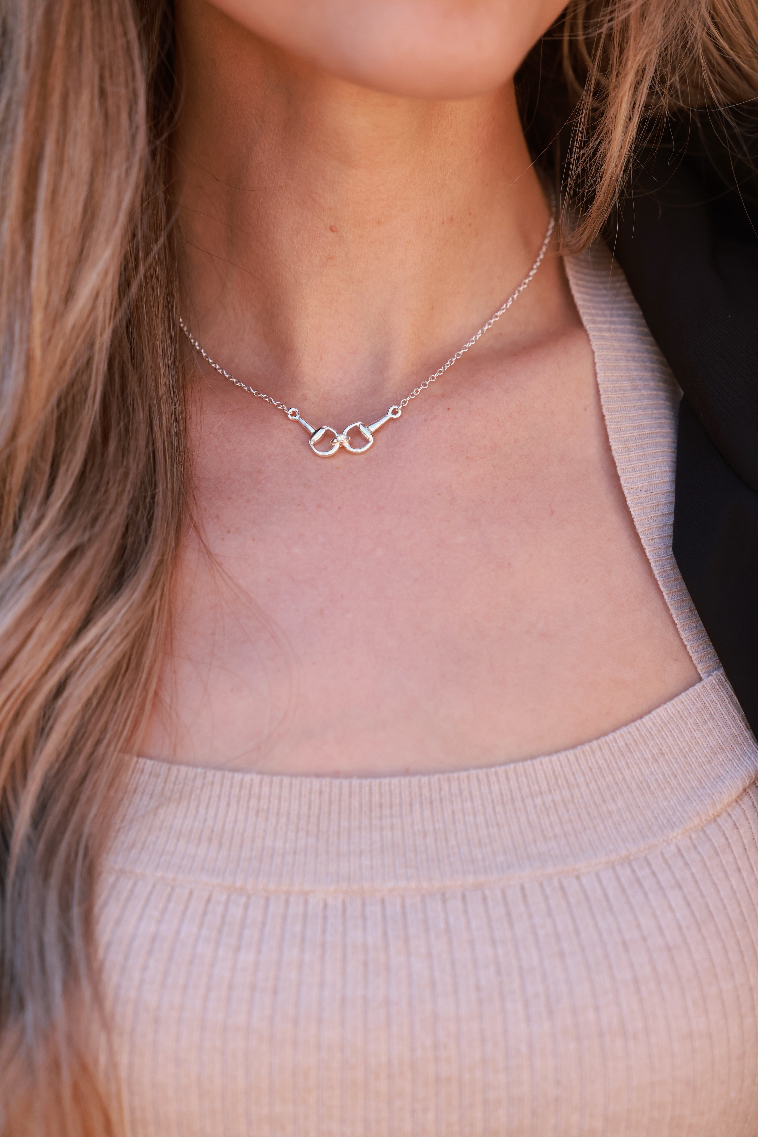 Silver necklace on a person wearing a beige top -equestrian inspired jewelry, horse girl accessory, horseshoe pendant necklace, dainty equestrian jewelry, small gifts for horse lovers