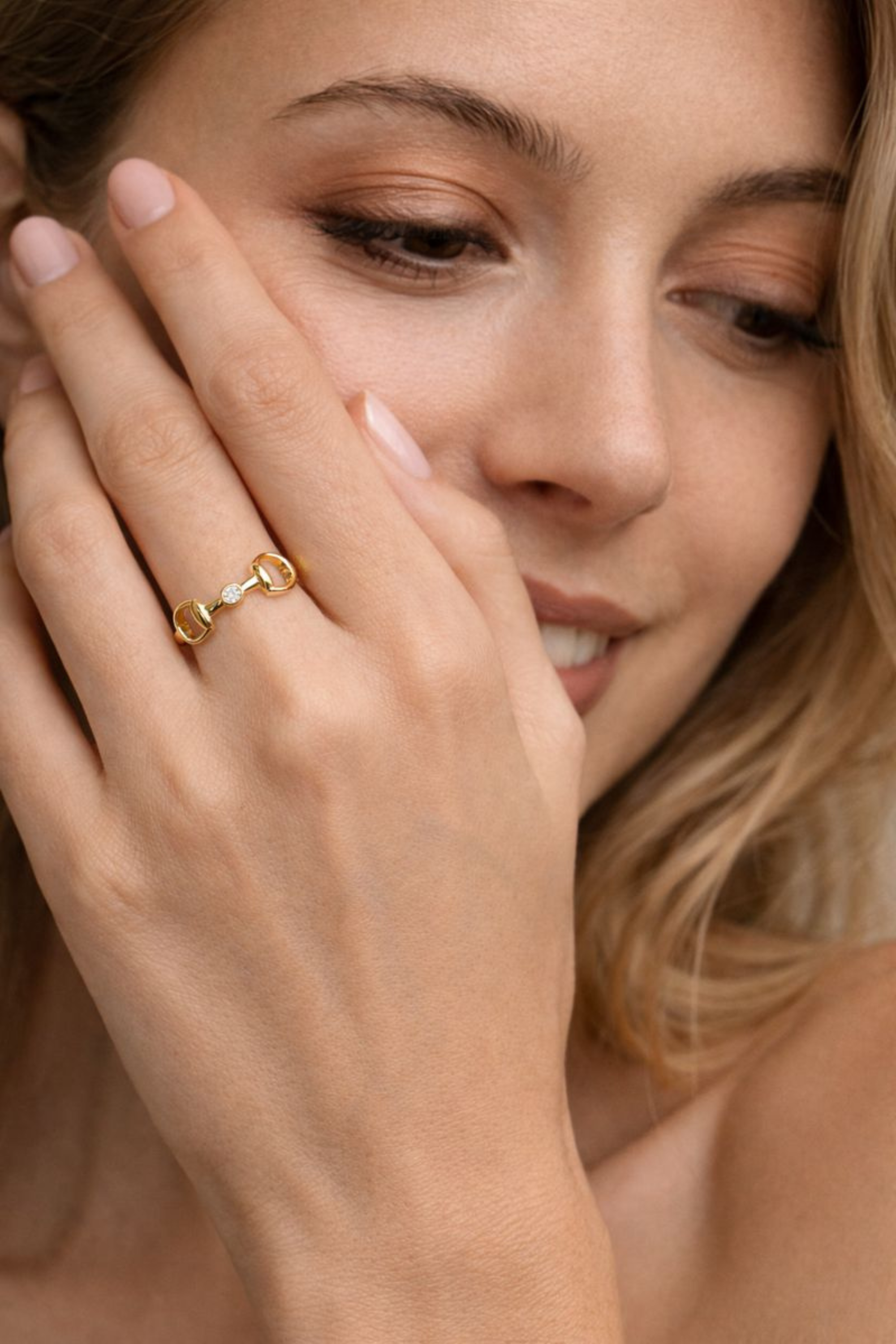 18k gold-plated equestrian horse bit ring with a bezel-set crystal accent, designed as a refined everyday statement piece.