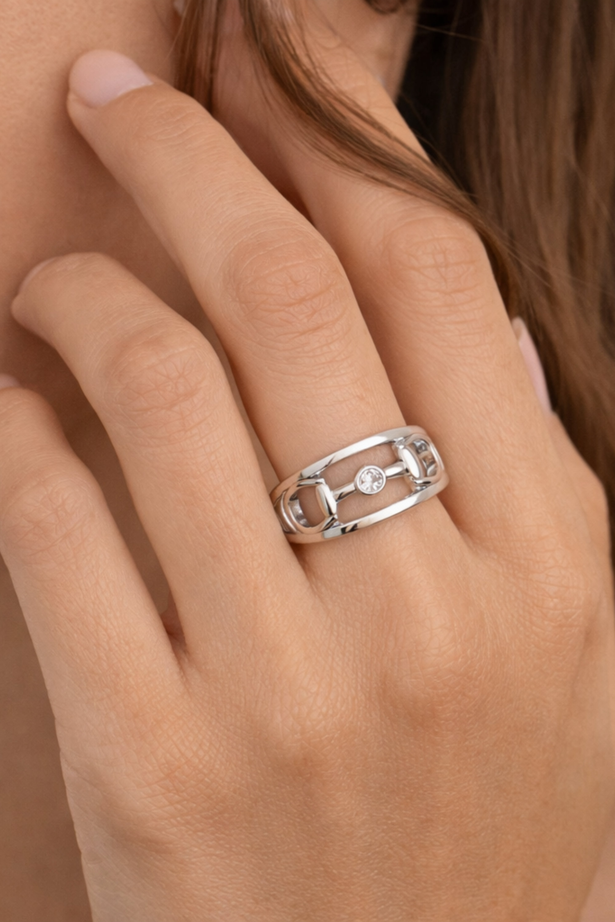 Silver Hollis double band ring featuring an equestrian horse bit centerpiece with a bezel-set crystal and minimalist stacked band design.