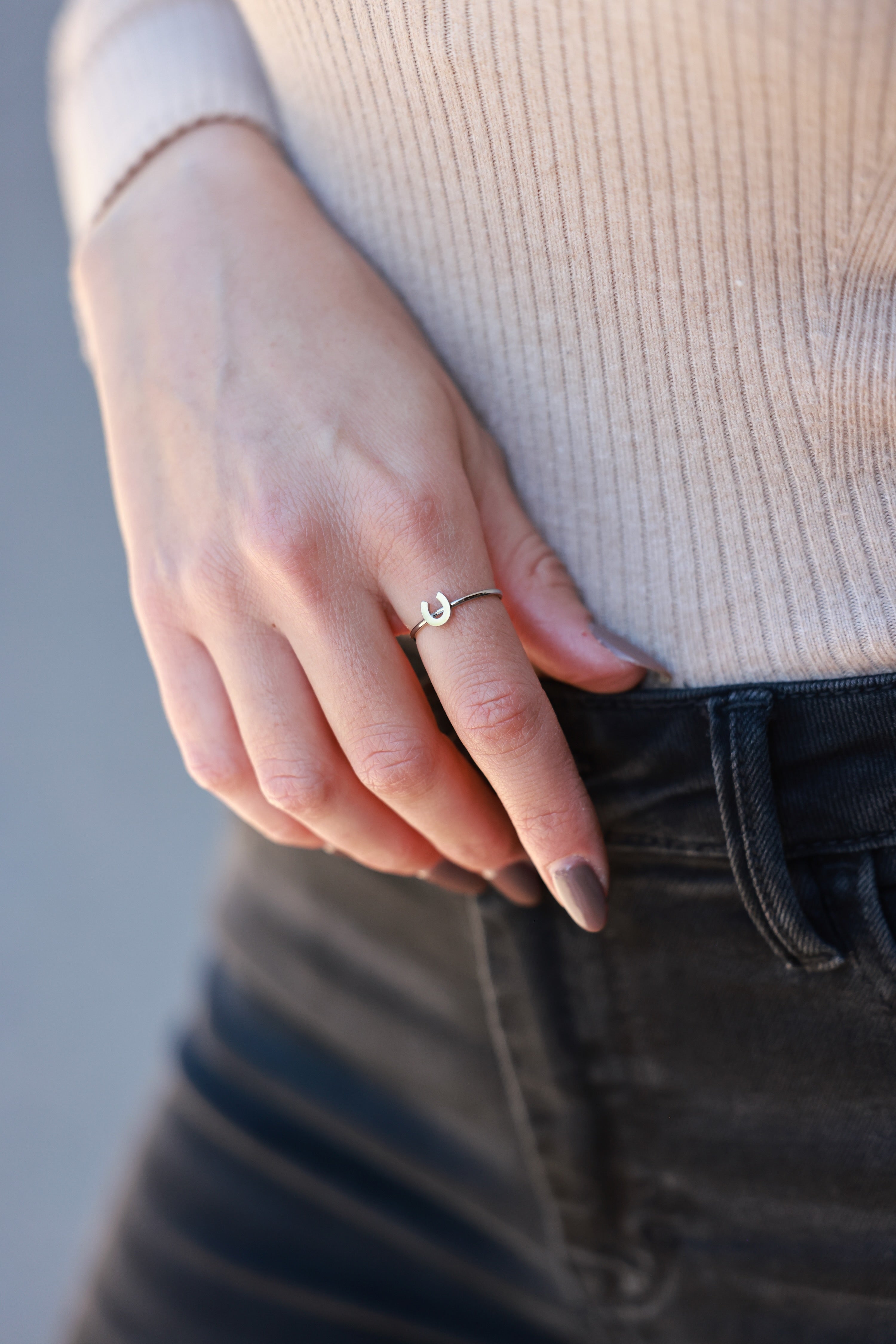 Silver Horseshoe Stacking Ring crafted in stainless steel with a dainty, minimalist profile. Water- and tarnish-resistant, hypoallergenic equestrian ring featuring the classic good-luck horseshoe — perfect for stacking or gifting to horse lovers.