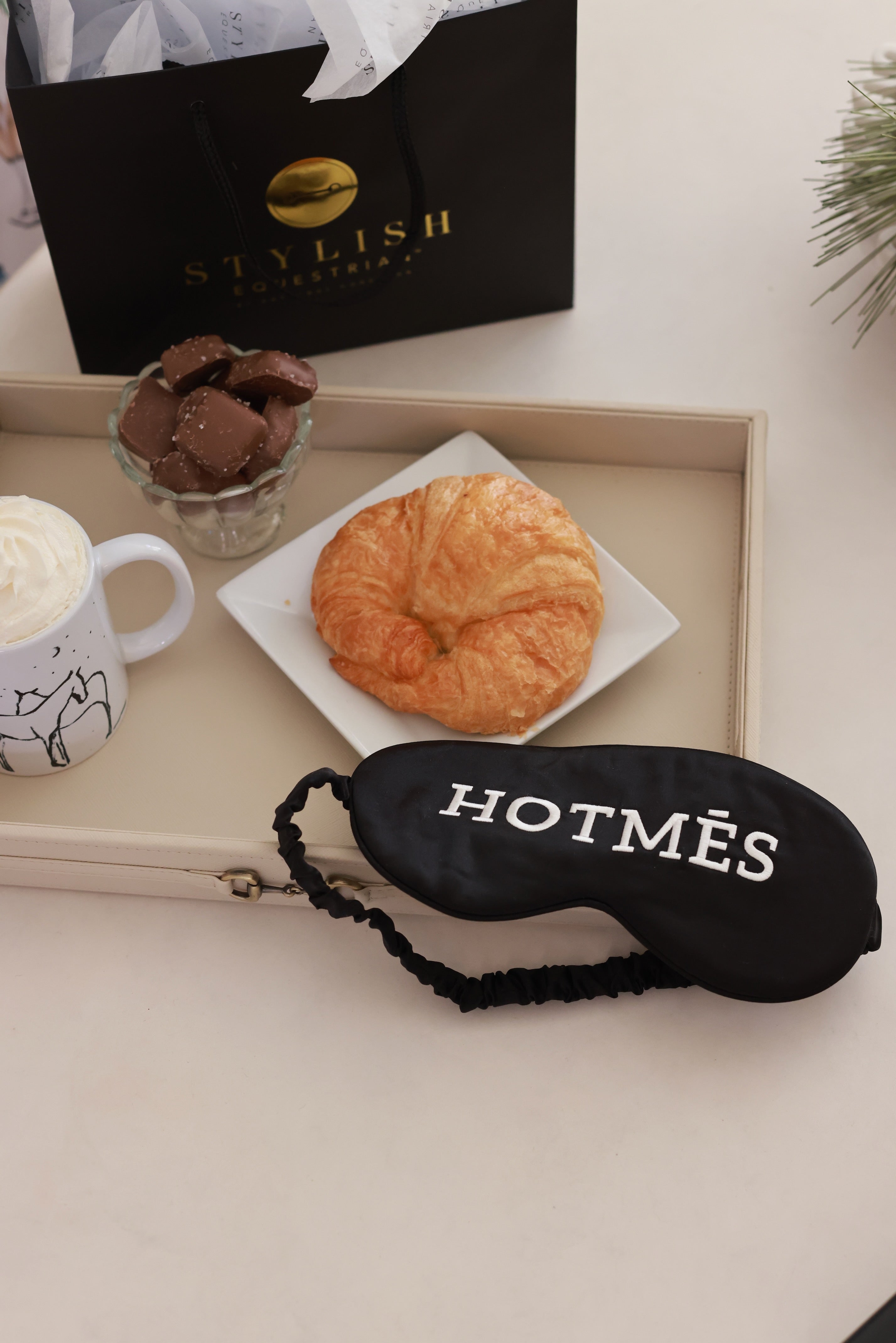 Hotmés Silk Sleep Mask made from 100% silk with front embroidery and elastic strap. Luxurious, comfortable, equestrian-inspired sleep accessory.