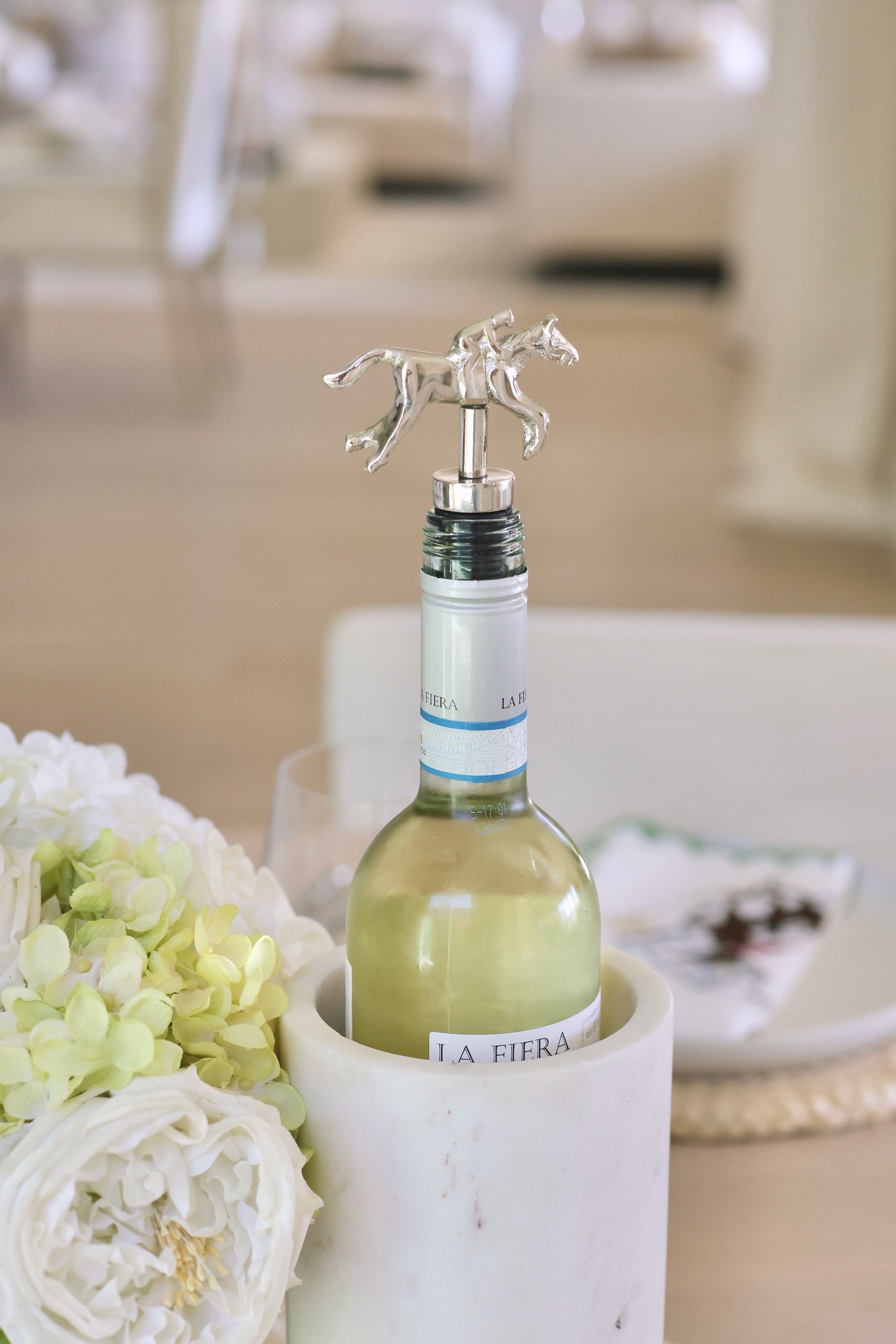 Pomegranate Jockey Bottle Stopper - Silver Elevate your entertaining with the Silver Jockey Bottle Stopper. Crafted with a charming horse & jockey design, this stopper not only preserves your wine's freshness but also adds a touch of equestrian elegance to your barware. Its durable construction ensures a secure fit, making it a delightful gift for horse lovers and wine enthusiasts alike.