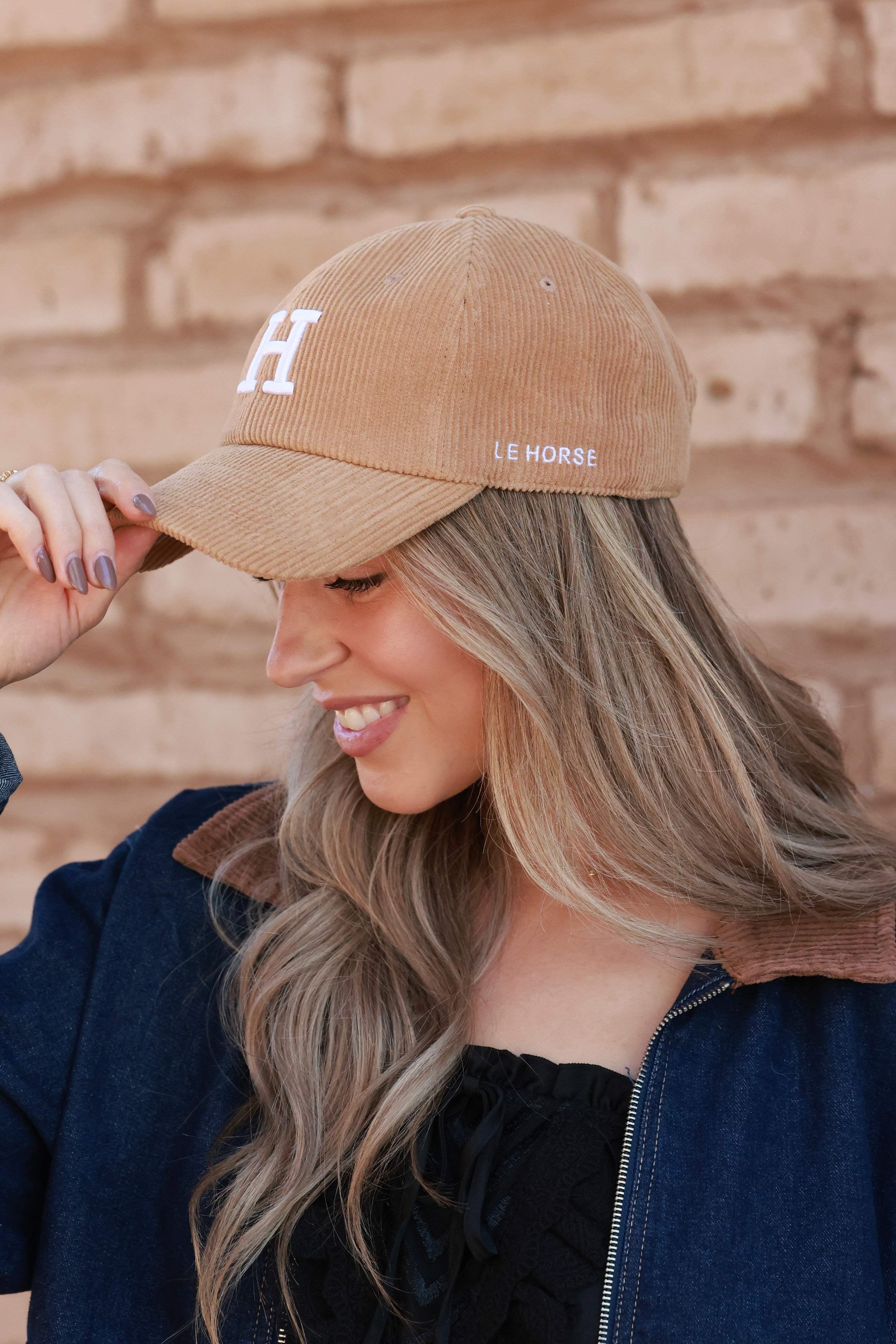 Camel Le Horse Corduroy Cap featuring trendy embroidered ‘H’ front and side Le Horse detail. Unstructured, low-profile six-panel design with pre-curved visor and adjustable strap for a comfortable fit.