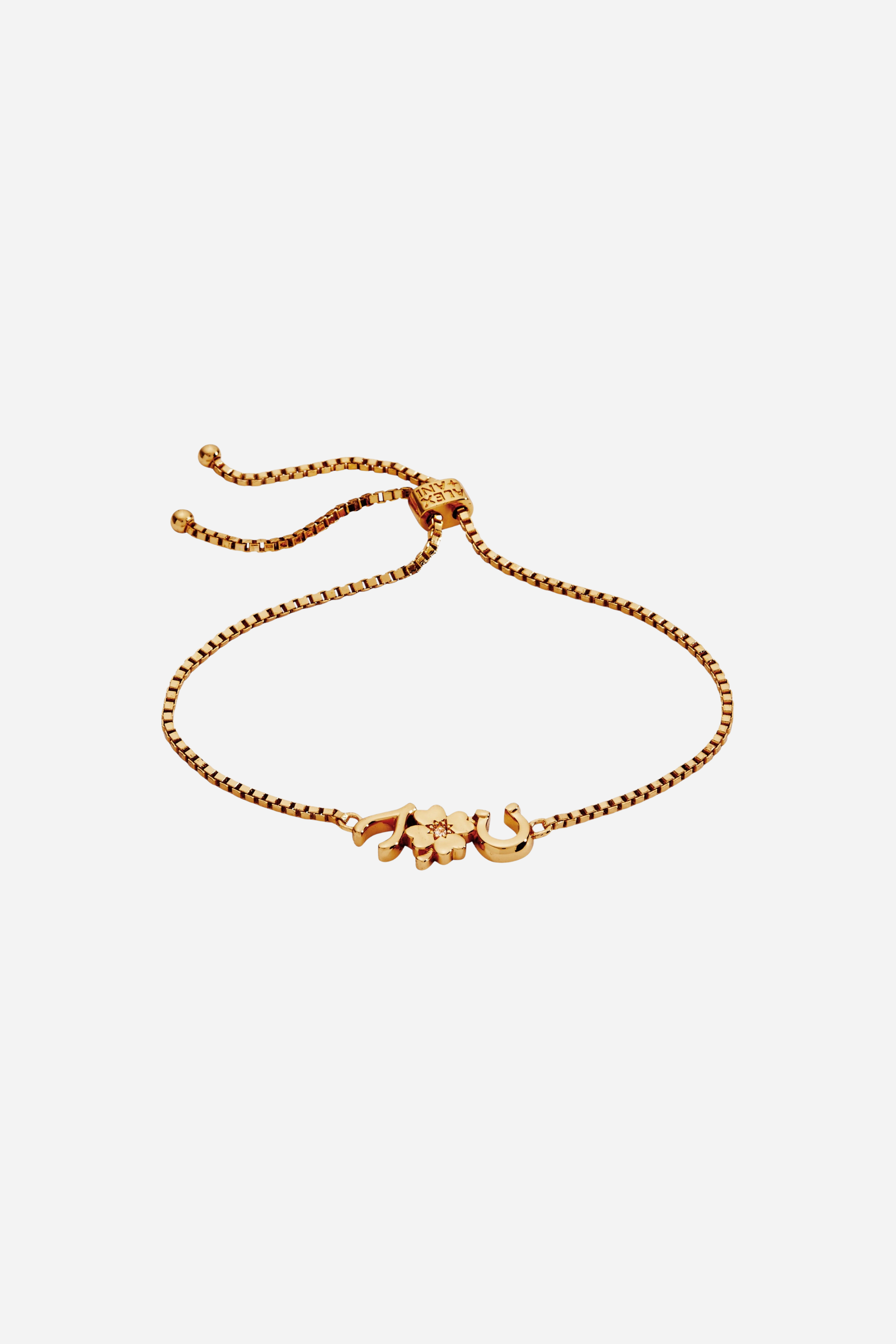 Gold-plated adjustable bolo bracelet featuring lucky charm symbols including a horseshoe, clover, and wishbone with crystal accents.
