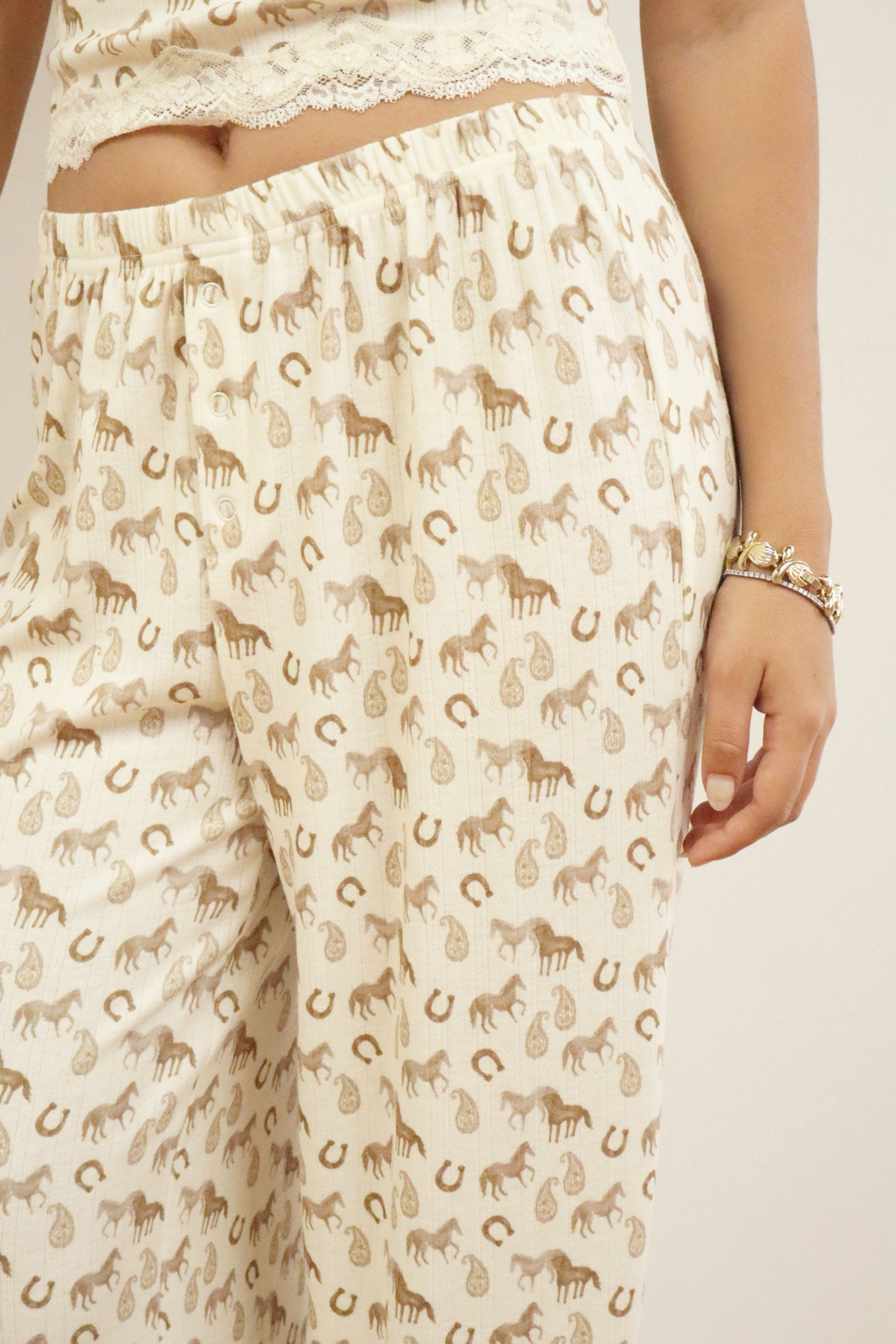 Lucky Charm horse print pajama set in pale cream with lace trim cami top, adjustable straps, and elastic waist pants.