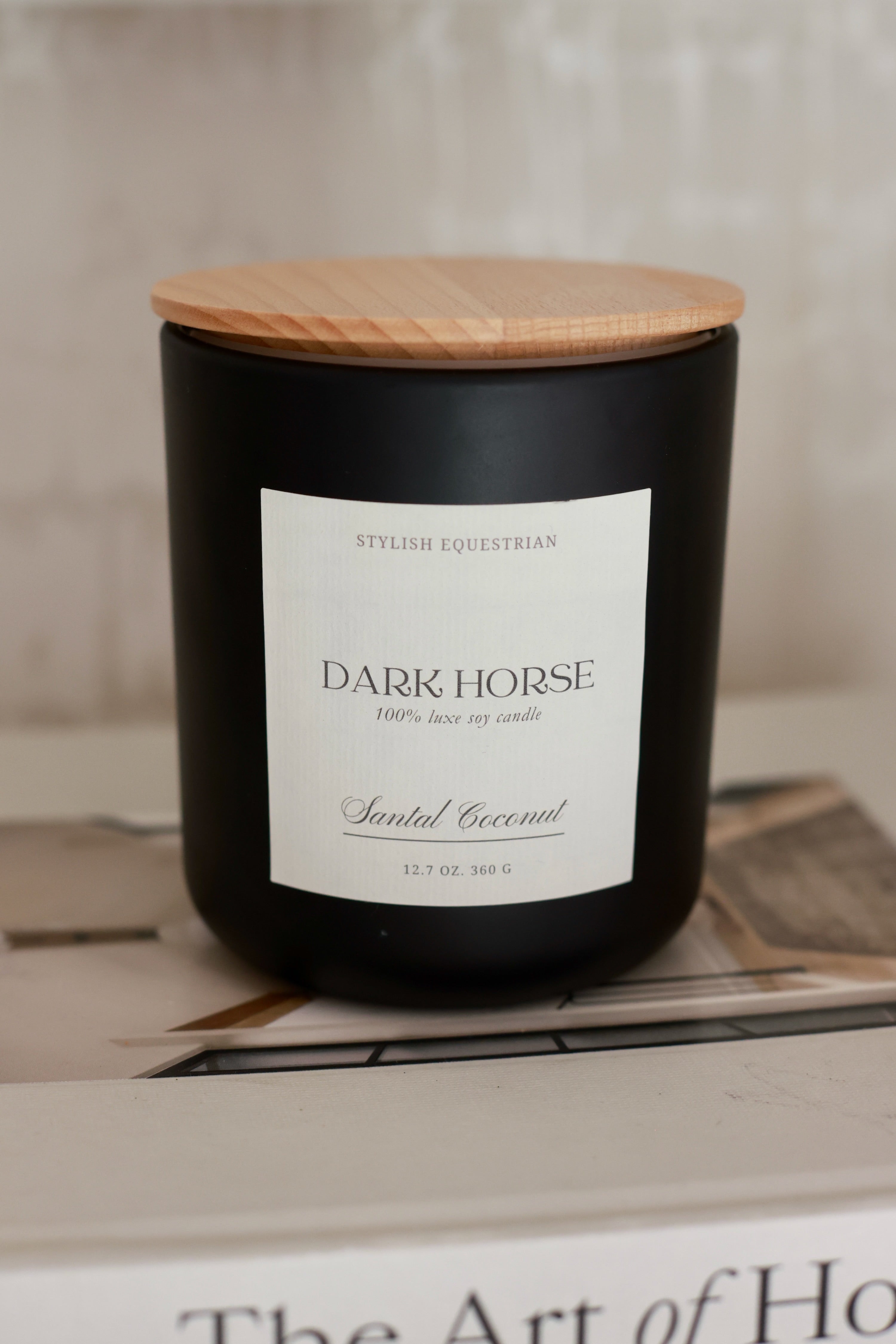 Luxe Signature Candle – Dark Horse edition, a handmade 100% soy wax candle in a frosted matte glass jar with wooden lid. Features a warm santal coconut scent with notes of amber, cedarwood, and vanilla. Elegant equestrian-inspired home accent with 60+ hour burn time. Made in the USA. equestrian decor and home accents, horse themed candle, gifts for horse lovers, luxury soy candle, santal coconut candle, Dark Horse candle, equestrian home fragrance, wooden lid candle, elegant horse gift