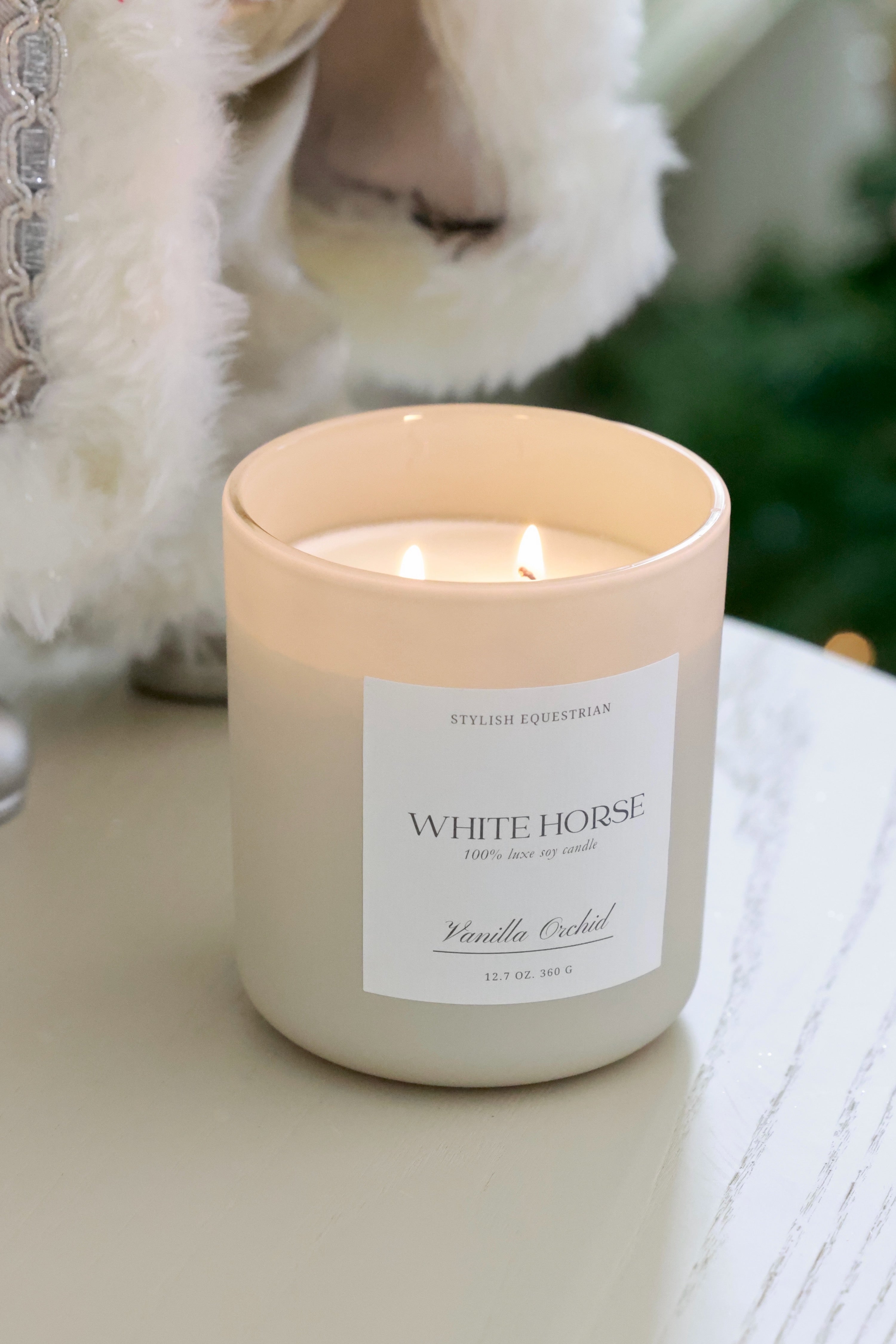 Luxe Signature Candle – White Horse edition, a handmade 100% soy wax candle in a frosted matte glass jar with wooden lid. Features a soothing Vanilla Orchid scent with notes of orange, green leaves, jasmine, sandalwood, and creamy vanilla. Elegant equestrian-inspired home accent with a 60+ hour burn time. Made in the USA. equestrian decor and home accents, horse themed candle, gifts for horse lovers, luxury soy candle, vanilla orchid candle, White Horse candle, equestrian home fragrance