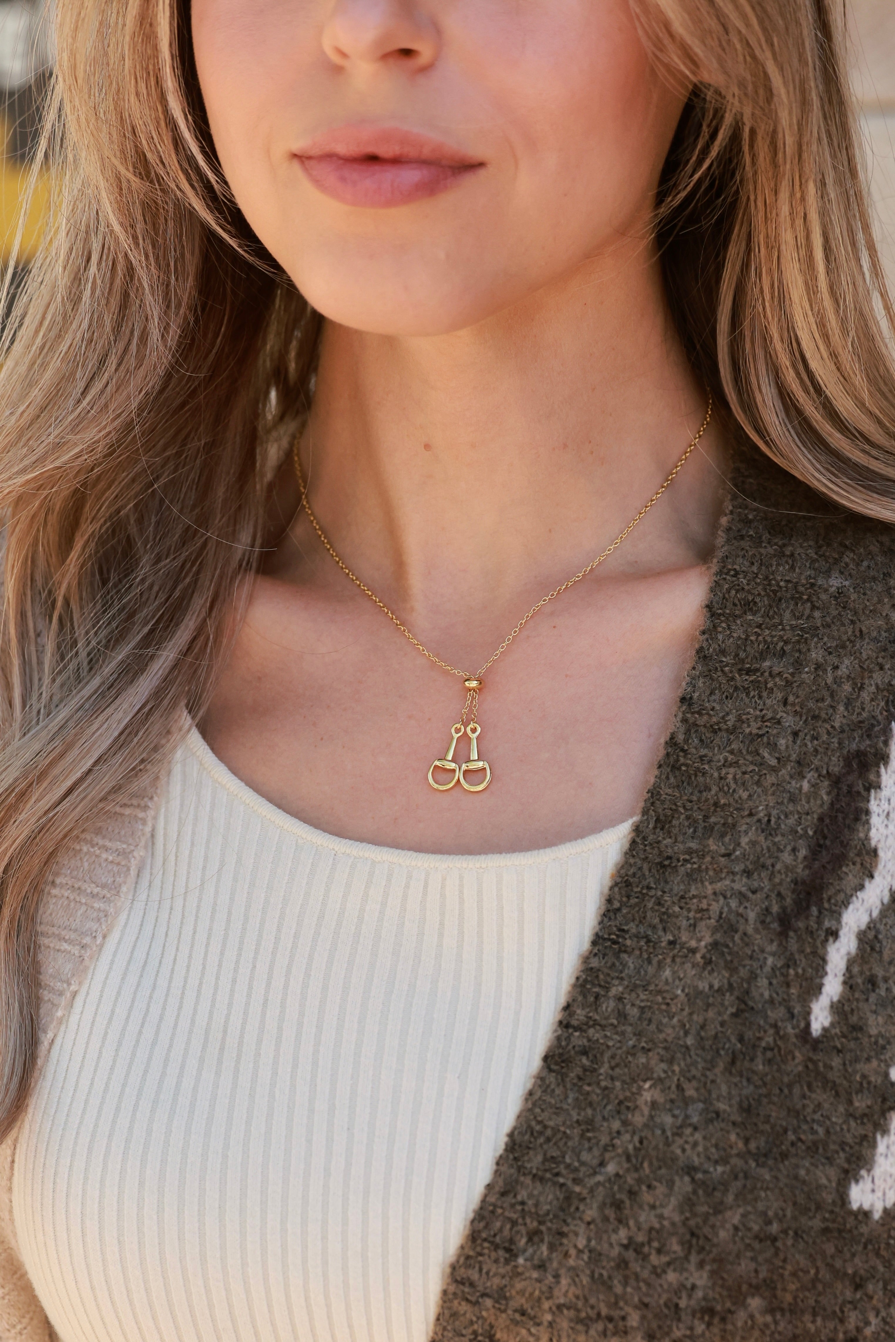 Gold equestrian necklace with adjustable sliding bead and drop pendants, dainty 18k gold horse girl jewelry, minimalist horseshoe-inspired necklace, elegant gift for horse lovers.