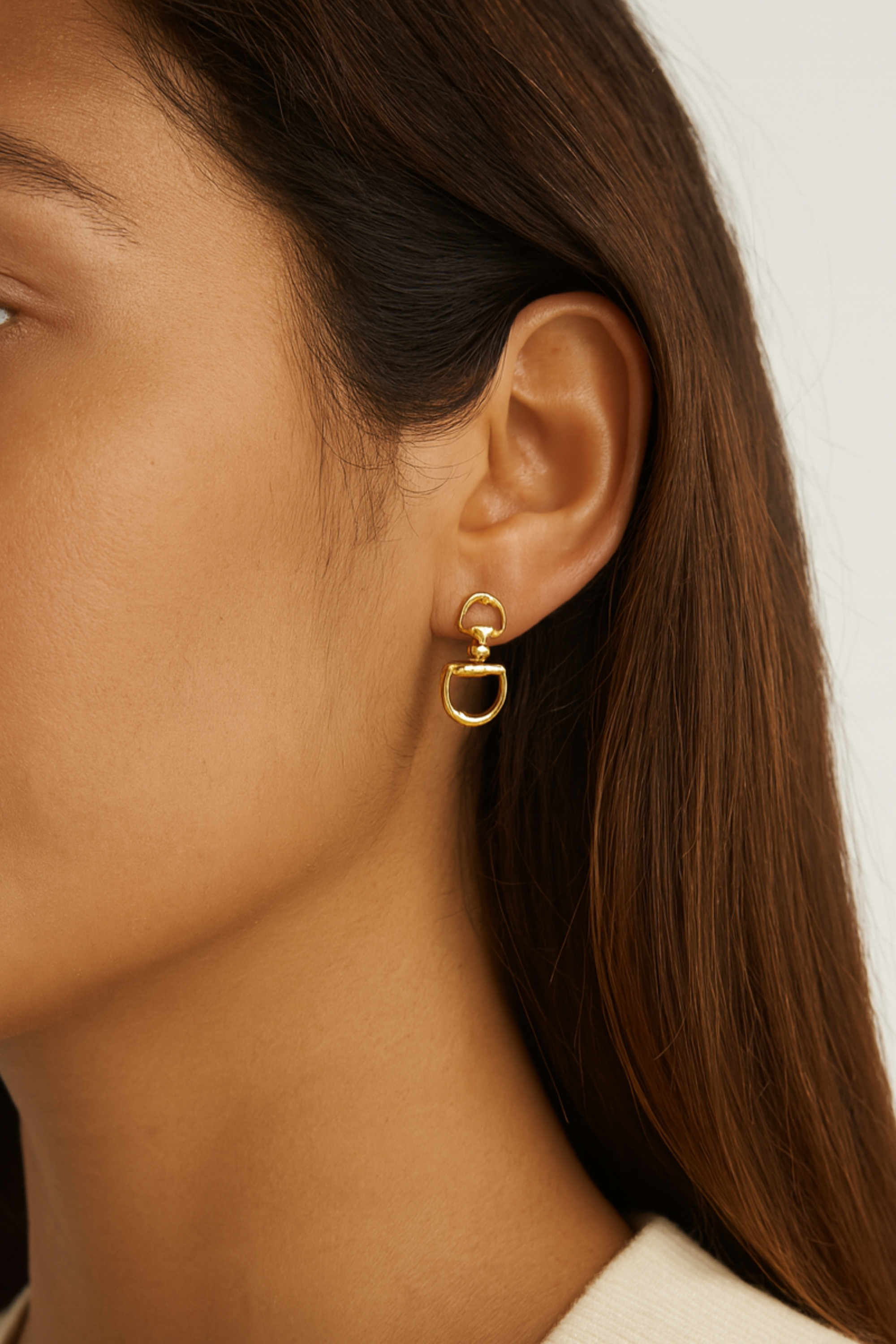 Gold d-ring drop earrings with interlocking circular links, minimalist 18k gold statement jewelry, modern equestrian-inspired earrings for women.