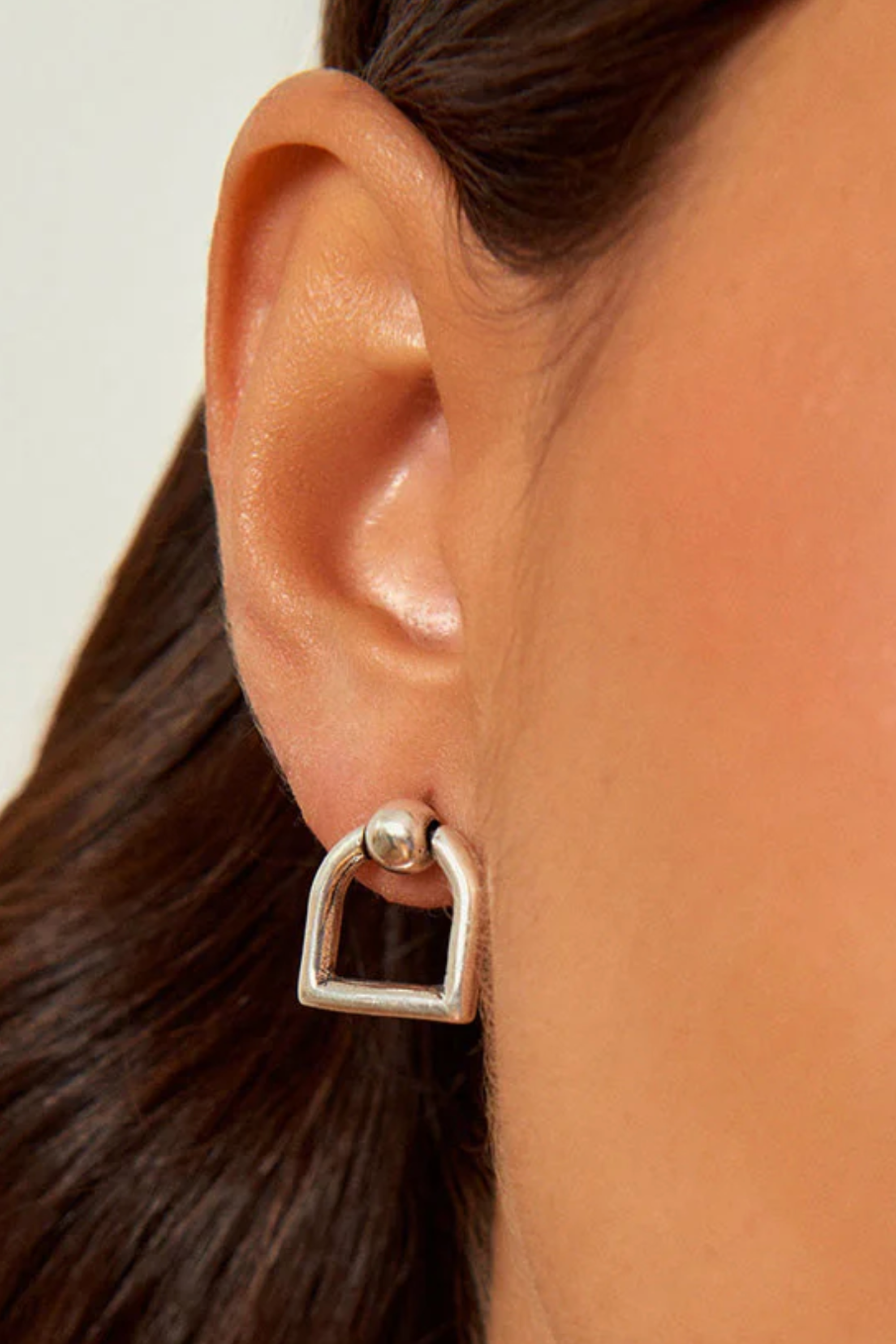 Maya stirrup stud earrings in silver plated metal with equestrian-inspired design. stirrup earrings, equestrian earrings, horse jewelry, horse themed earrings, equestrian jewelry, horse girl jewelry