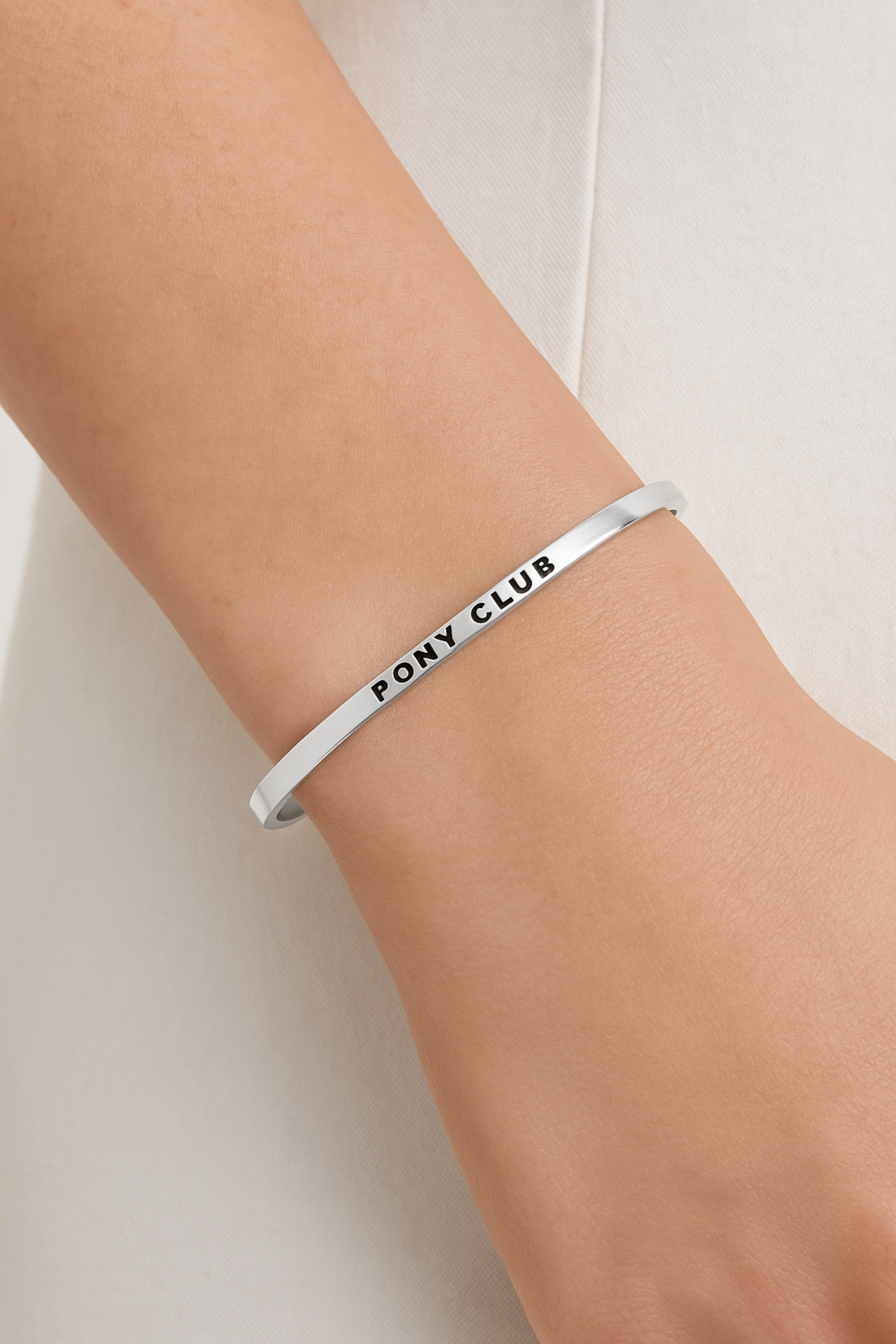 Gold-dipped stainless steel bangle engraved with an equestrian-inspired affirmation. Elegant and adjustable design for horse lovers, featuring a sleek, minimalist finish. Shown as part of the Pony Club collection, symbolizing strength, joy, and love for riding.