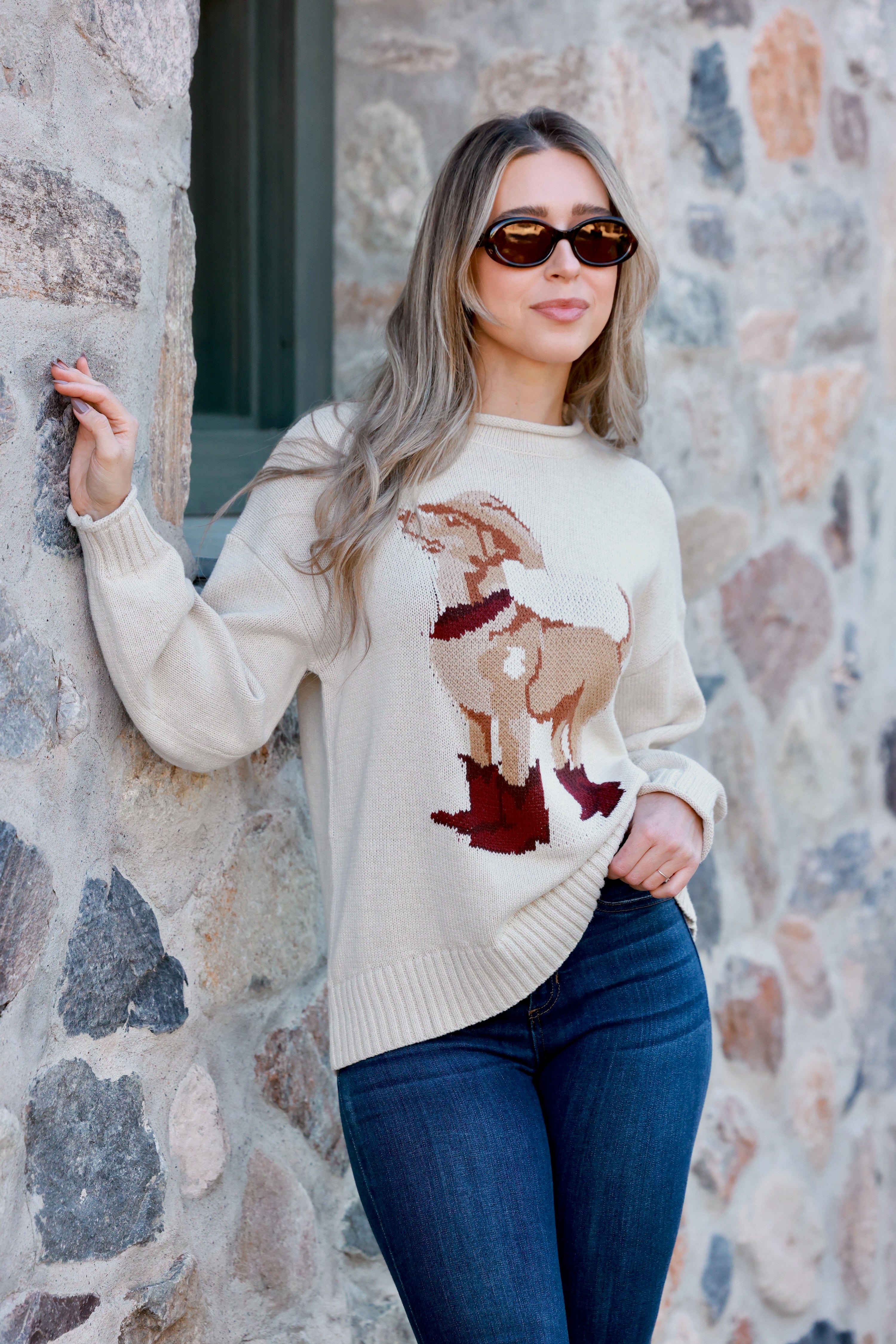 A cozy Ralph Western Sweater featuring a playful knit dog wearing a cowboy hat, boots, and scarf. The pullover has a relaxed fit with ribbed hems and cuffs, a mock neck, and a soft cotton-acrylic knit. Shown in heather grey or rust, styled casually with jeans. WESTERN DOG MOTIF PULLOVER SWEATER - WESTERN COWYBOY GRAPHIC, ANIMAL, DOG, LOOSE AND COMFORTABLE