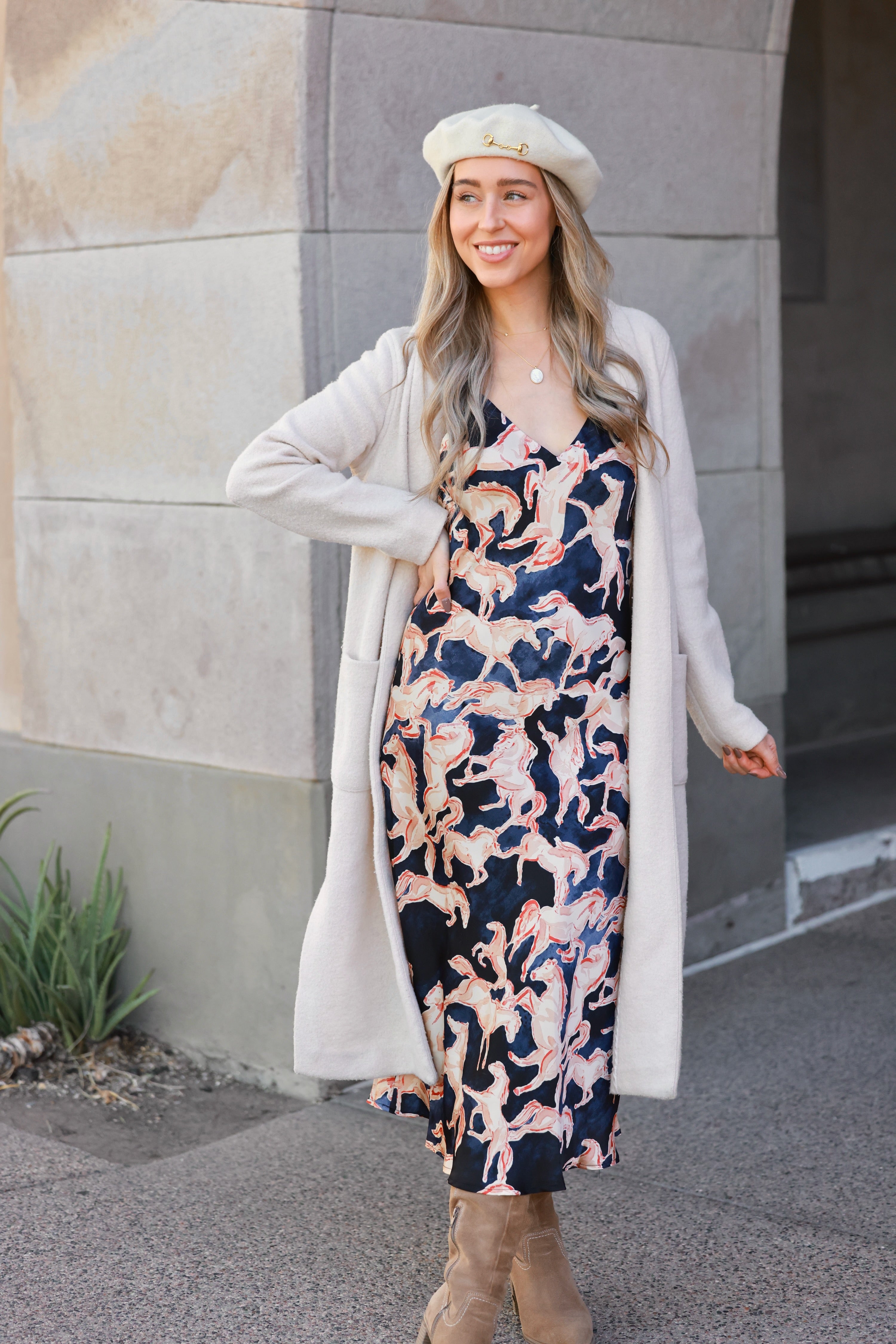 Woman wearing a dress with horse pattern against a neutral background - Western slip dress, Horse print satin dress, Bias cut midi dress, Navy equestrian dress, Vintage-inspired slip dress, Cocktail party dress, Day party outfit, Western navy satin dress, Women’s equestrian fashion, Retro western slip dress