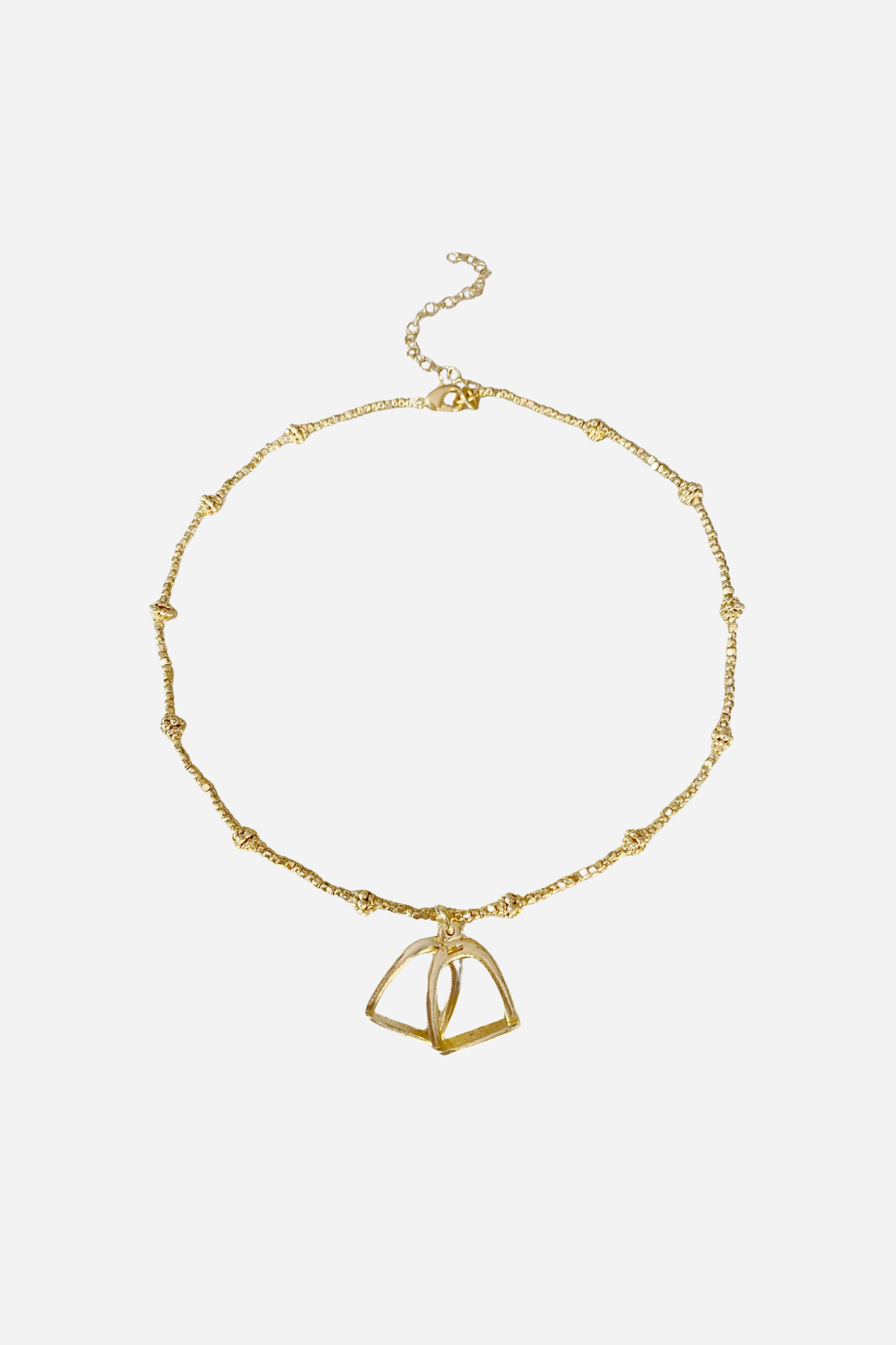 Delicate and dazzling stirrup necklace with lightweight stirrups strung between shimmering beads. 15-inch length with adjustable extender chain.