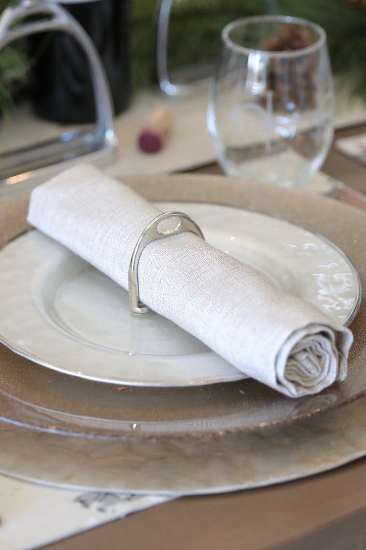 lilo collections stylish equestrian stirrup napkin ring set Silver Stirrup Napkin Ring Set featuring four polished silver stirrup-shaped rings with a leather top closure for easy storage. A best-selling equestrian-inspired table accessory perfect for elegant dining or gifting to horse lovers.