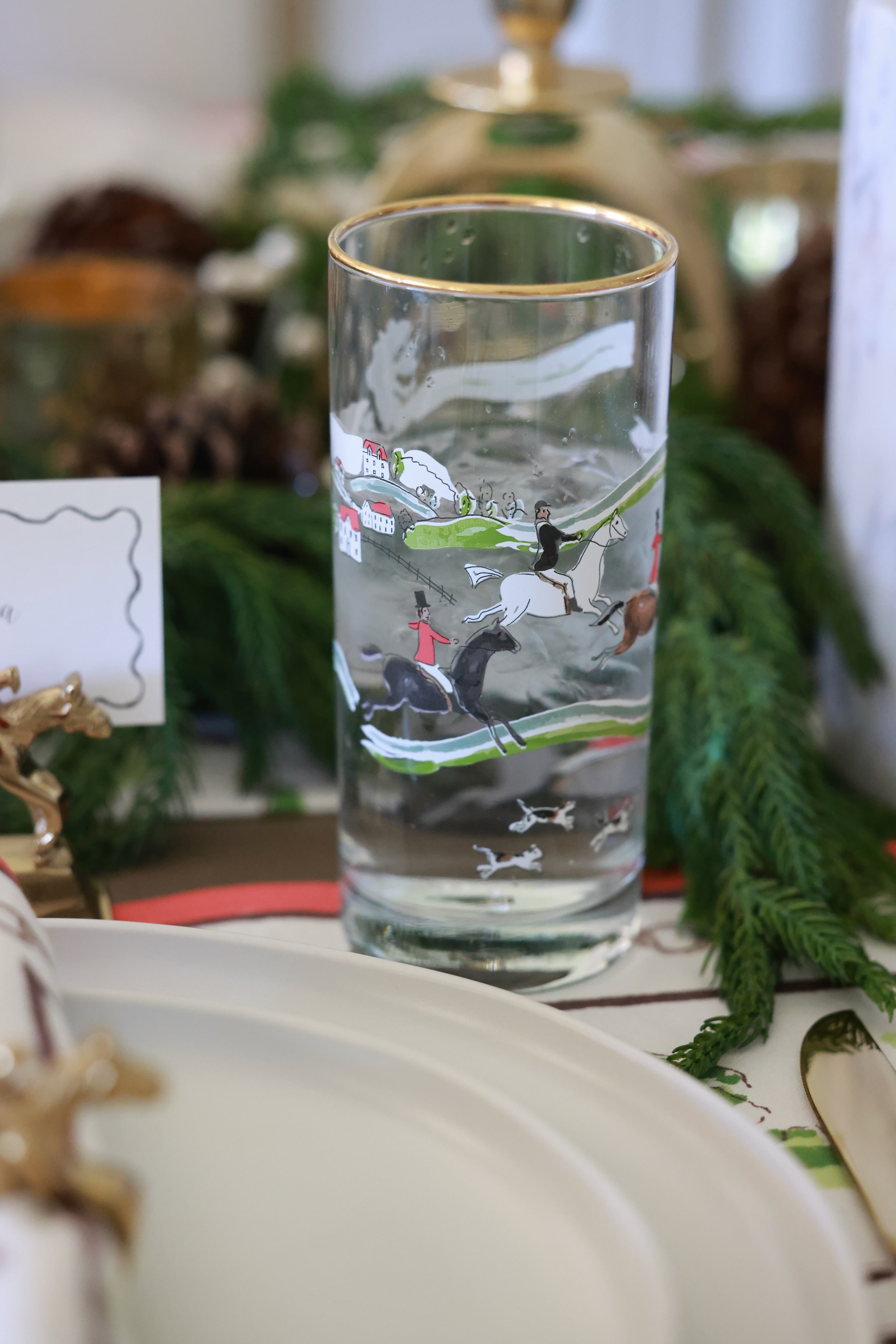 pomegranate inc stylish equestrian the hunt scene tall drinking glass set The Hunt Scene Drinking Glass Set featuring four tall glasses adorned with a detailed equestrian hunt scene and finished with elegant gold rims. A sophisticated horse-themed glassware set perfect for entertaining or gifting.