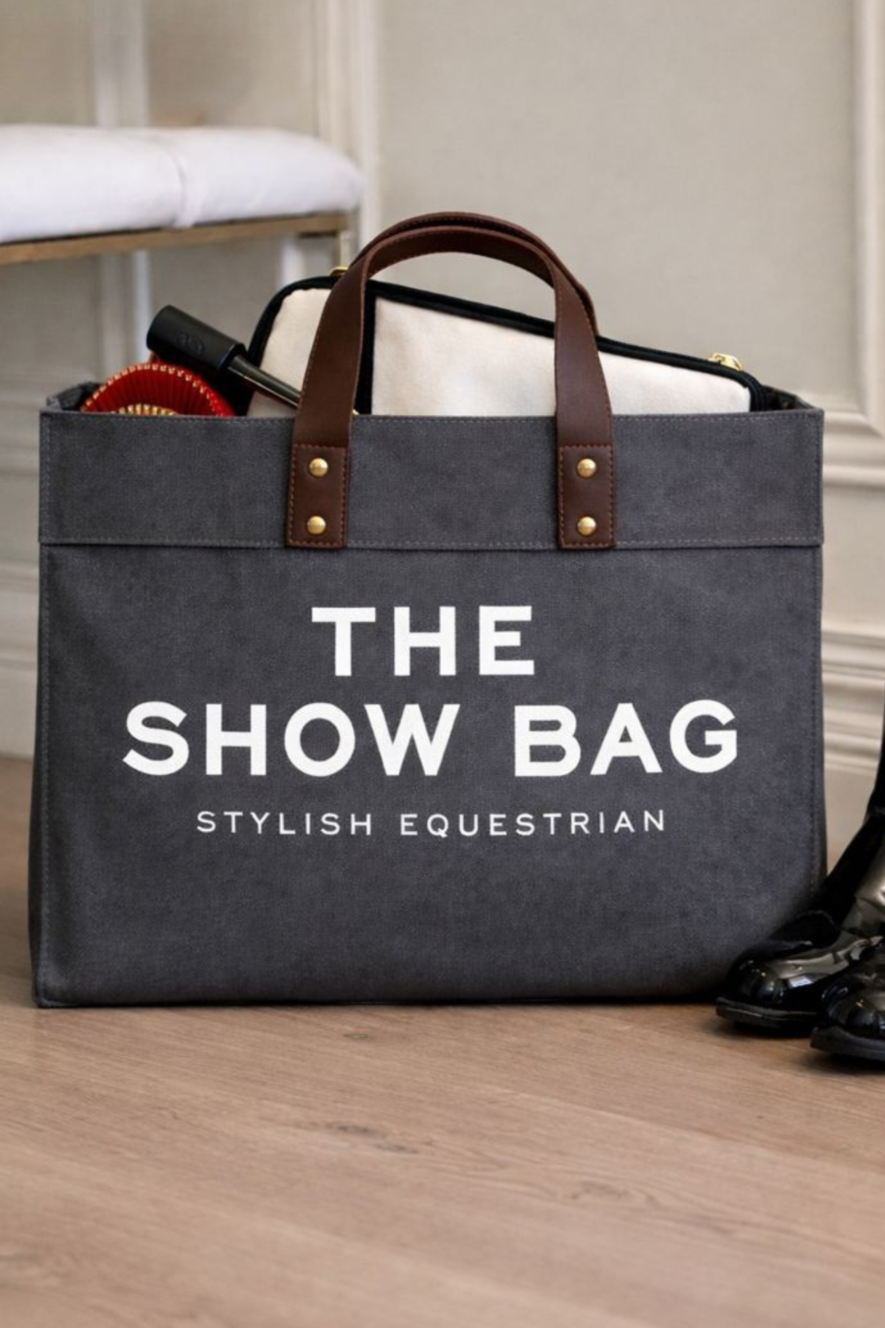 Canvas equestrian show bag tote with a cheeky front print, black leather handles, and spacious interior with side pockets for essentials.