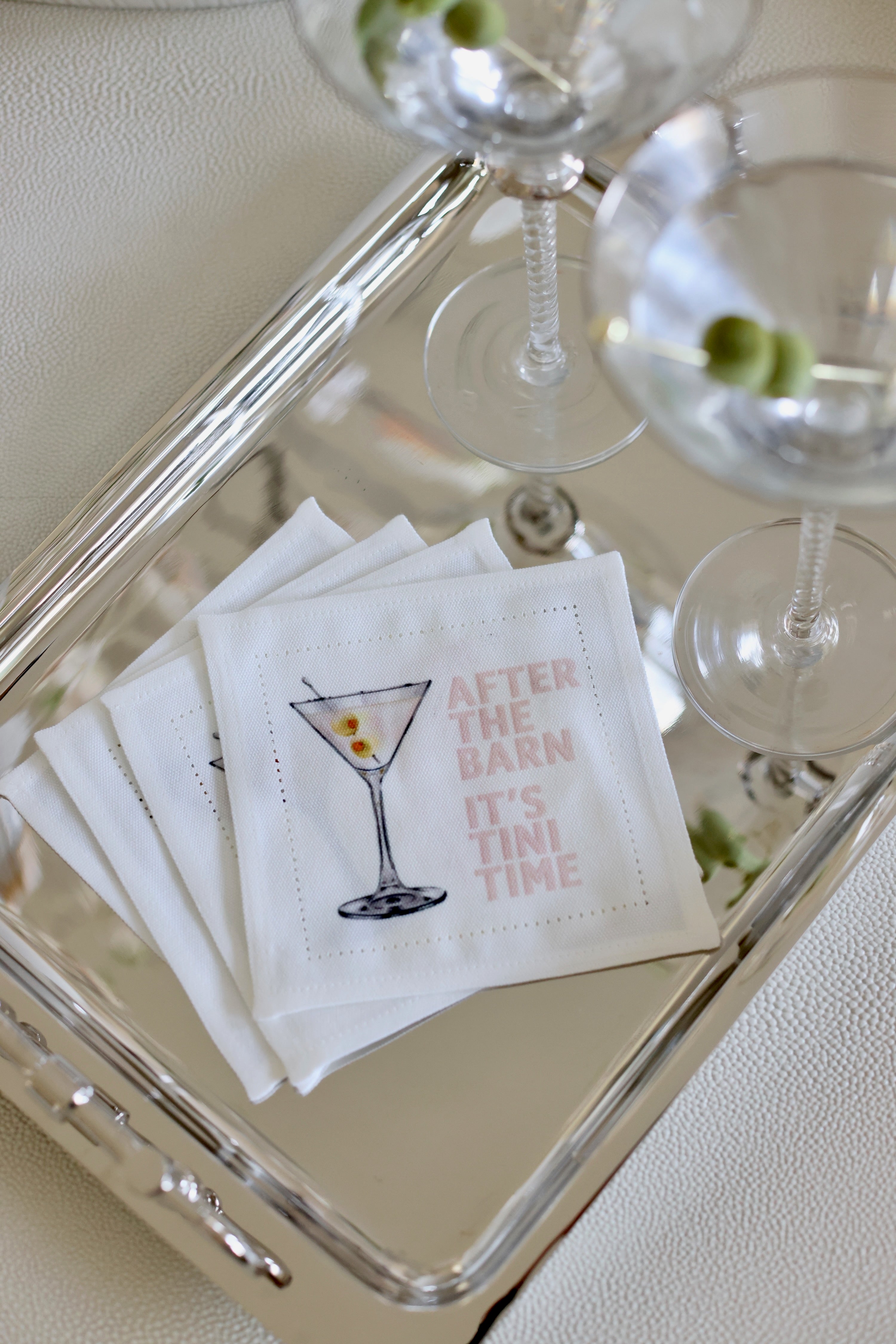 Cocktail napkins with a martini illustration and text on a tray with glasses. - equestrian kitchen and dining, horse themed linens, equestrian hand towel, martini napkin