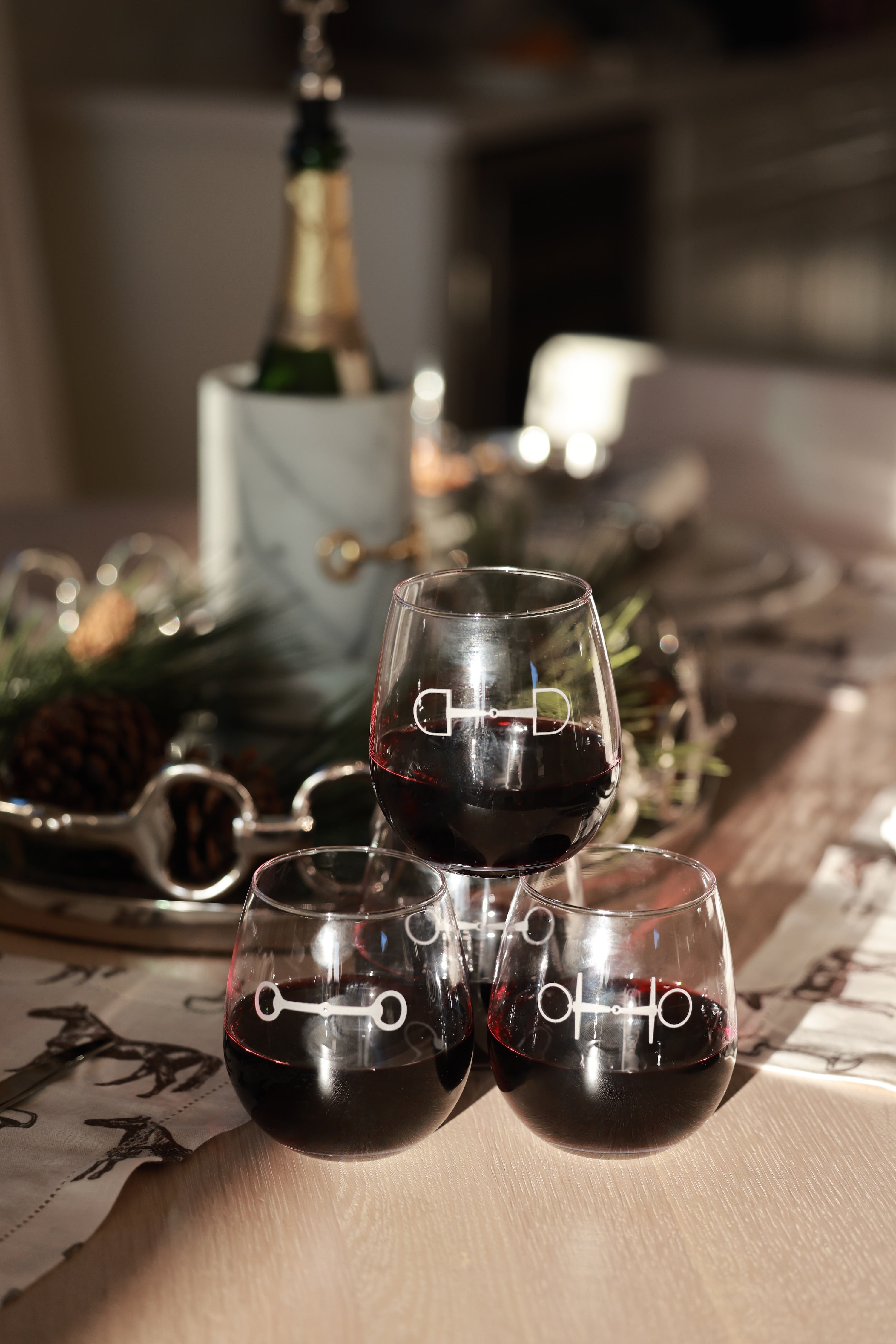Troop of Horses Stemless Glass Set by Stylish Equestrian — elegant set of four 16 oz. stemless glasses, each hand-sandblasted with a unique horse bit design. Perfect equestrian-inspired glassware for entertaining, gifting, or home bar styling. Adds refined horse lover charm to any table setting. equestrian kitchen and dining, horse themed glassware, equestrian barware, horse bit wine glass set, luxury equestrian home decor, horse lover gift, elegant equestrian entertaining