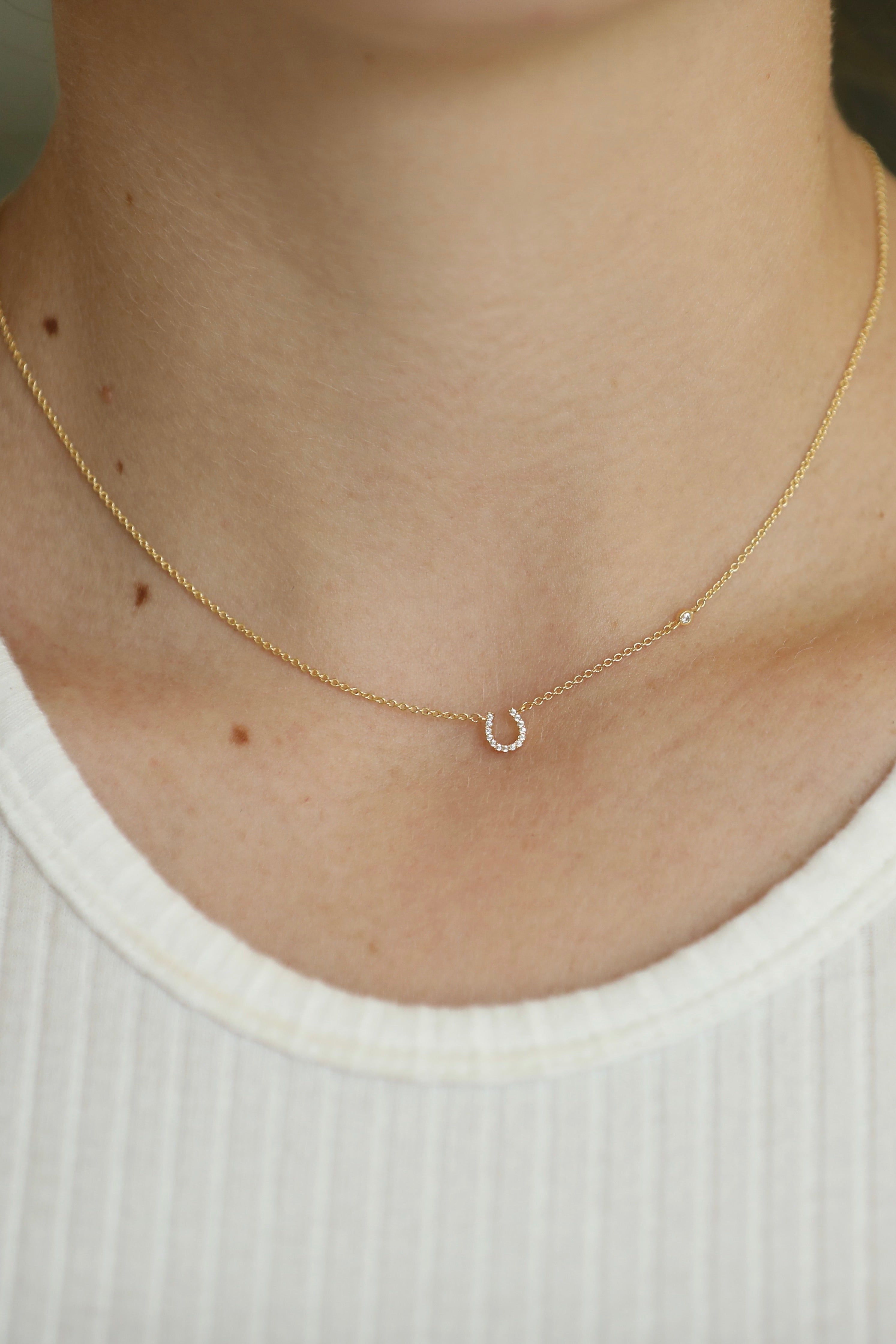 tai jewelry stylish equestrian gemma dainty horseshoe necklace gold | Equestrian-inspired dainty horseshoe necklace featuring a pavé CZ horseshoe charm and CZ accent on an adjustable chain.